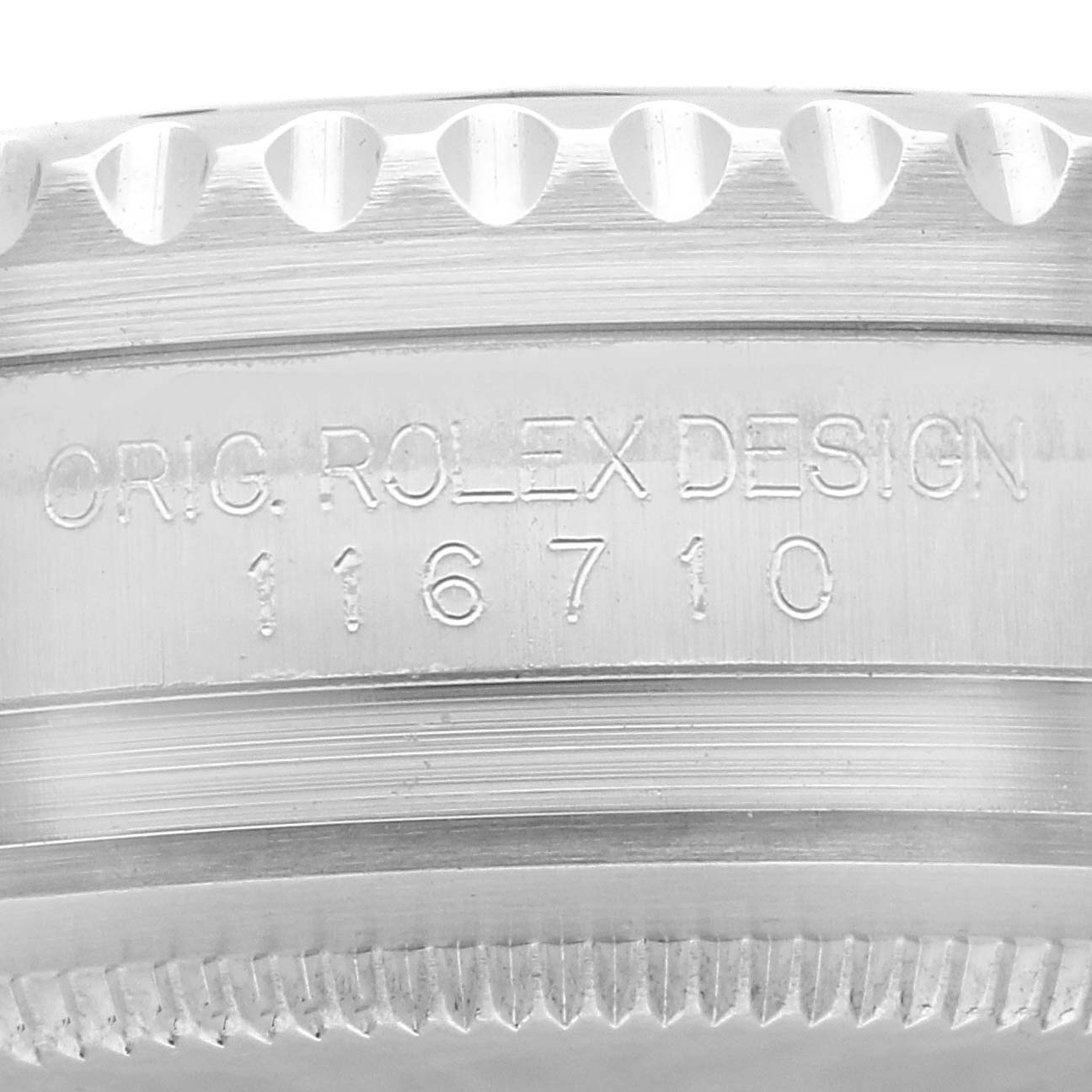 This image shows a close-up of the side engraving on a Rolex GMT-Master 116710LN Men
s Stainless Steel Black Dial 116710LN Men
s Stainless Steel Black Dial watch, displaying "OYSTER ROLEX DESIGN 116710".