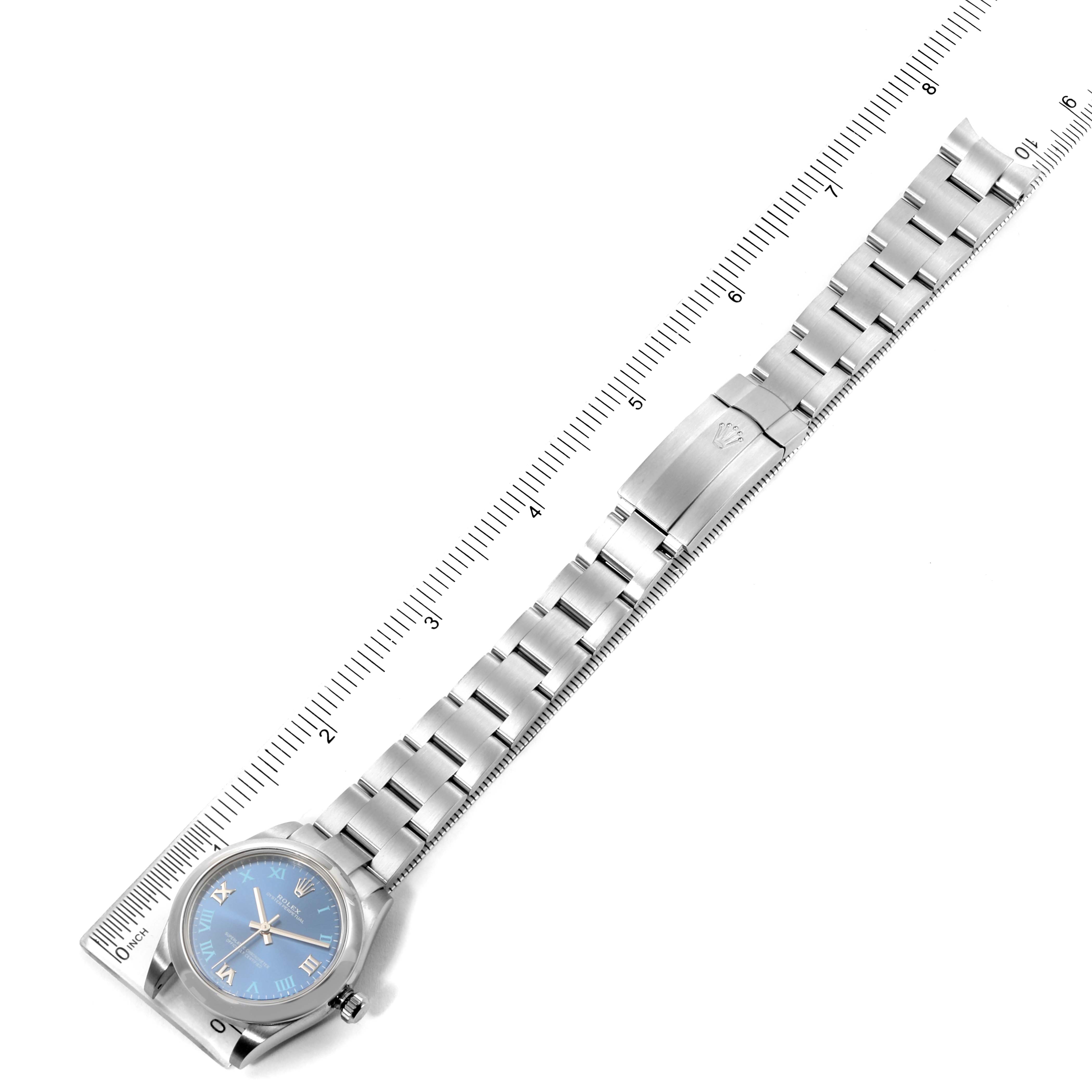 The Rolex Mid-Size 177200 Women
s Stainless Steel Blue Dial 177200 Women
s Stainless Steel Blue Dial watch is shown from a top-down angle, displaying the face, band, and clasp, measured against a ruler.