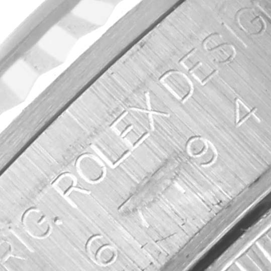 The image shows a close-up of the inner bezel of a Rolex Oyster Perpetual 67194 Women's Stainless Steel Silver Dial 67194 Women's Stainless Steel Silver Dial, highlighting engraved text.