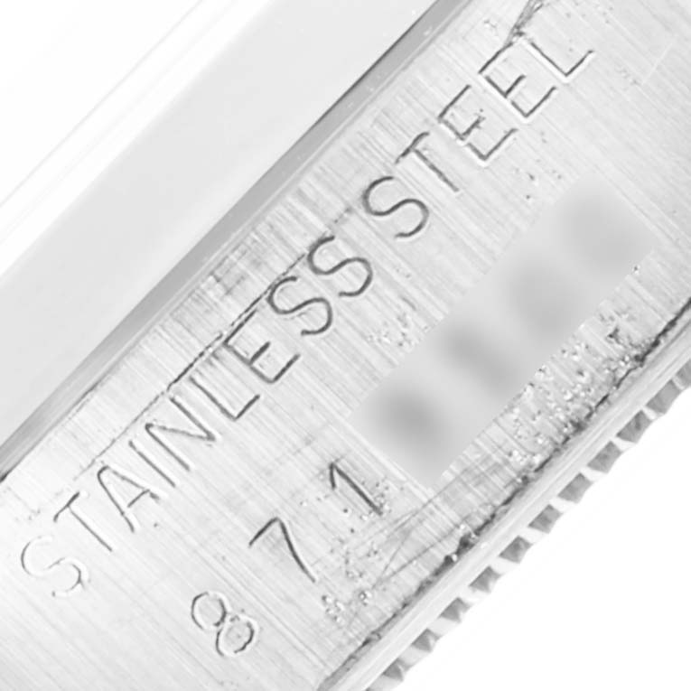 This close-up angle shows the engraved "STAINLESS STEEL" label on the case of a Rolex Vintage Collection 6694 Men's Stainless Steel Silver Dial 6694 Men's Stainless Steel Silver Dial model.