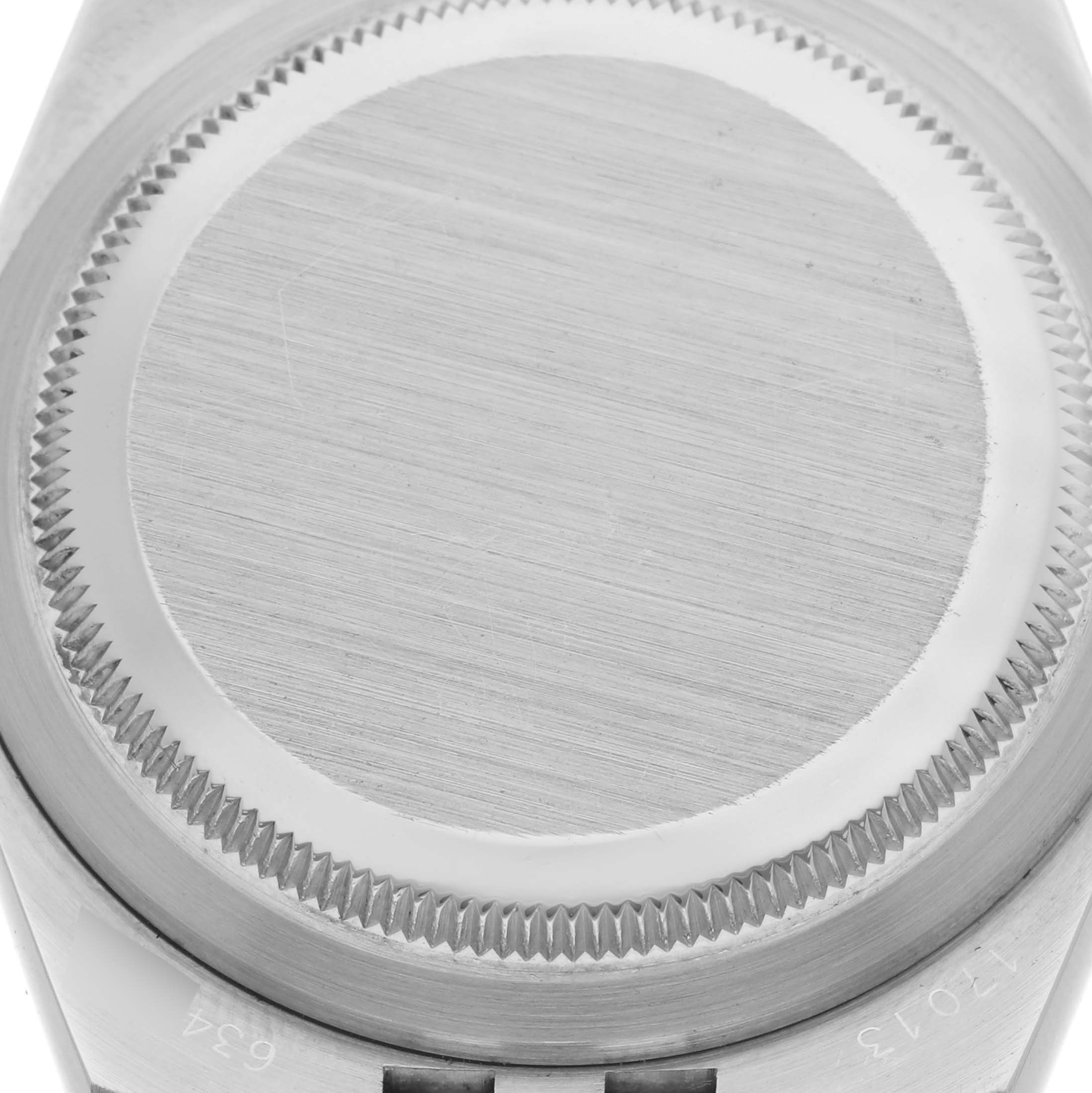 The image shows the back case of a Rolex Oysterquartz 17013 Men's Steel and Gold (two tone) Champagne Dial 17013 Men's Steel and Gold (two tone) Champagne Dial, focusing on its brushed finish and grooved edge.