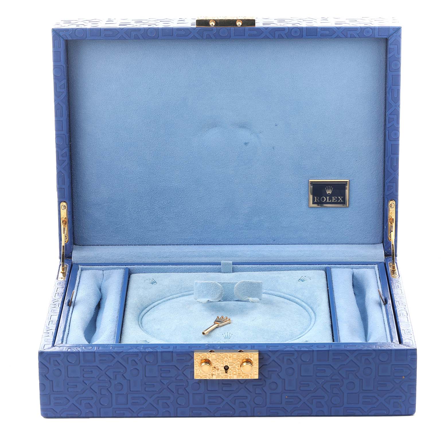 The image shows an open Rolex Pearlmaster 69298 Women
s Yellow Gold Champagne Dial 69298 Women
s Yellow Gold Champagne Dial box with a blue interior, featuring a watch cushion and a small golden key.