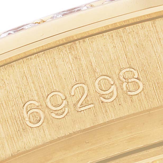 The image shows a close-up of the Rolex Pearlmaster 69298 Women
s Yellow Gold Champagne Dial 69298 Women
s Yellow Gold Champagne Dial
s watch bezel or case, focusing on the engraved numbers.