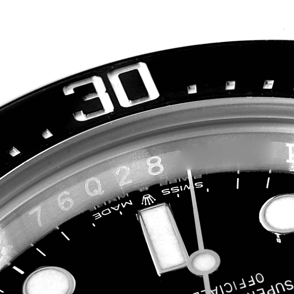 This close-up image shows the bezel and part of the dial of a Rolex Sea-Dweller 126600 Men
s Stainless Steel Black Dial 126600 Men
s Stainless Steel Black Dial watch.
