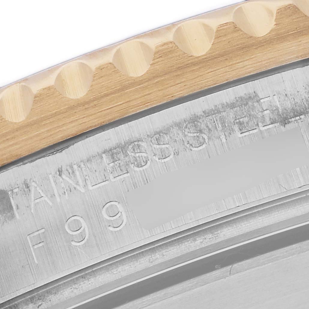 The image shows a close-up of the case edge and bezel teeth of a Rolex Submariner 16613 Men's Steel and Gold (two tone) Grey Dial 16613 Men's Steel and Gold (two tone) Grey Dial, highlighting the metal texture and markings.