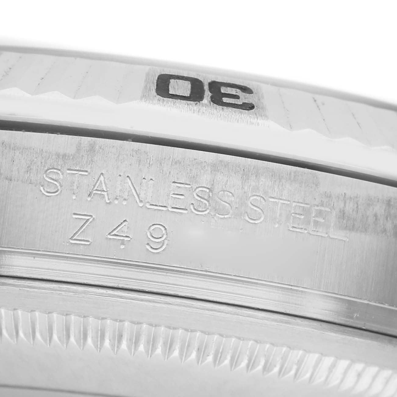 The image shows a close-up of the bezel and edge of the casing of a Rolex Turn-o-Graph 116264 Men's Stainless Steel Black Dial, highlighting its stainless steel.