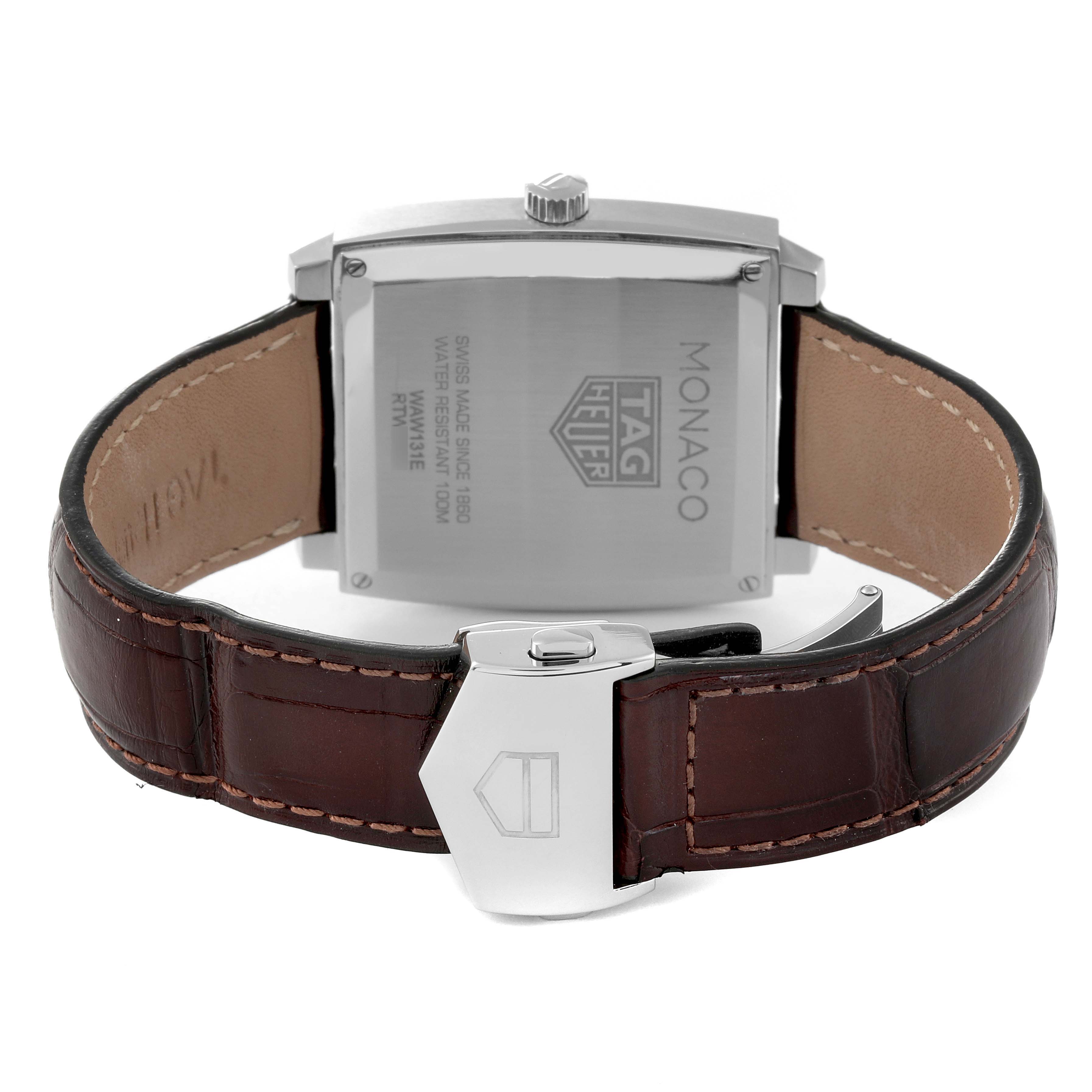 The image shows the back view of a Tag Heuer Monaco WAW131E.FC6420 Men's Stainless Steel Brown Dial WAW131E.FC6420 Men's Stainless Steel Brown Dial watch, featuring its case back and brown leather strap with clasp.