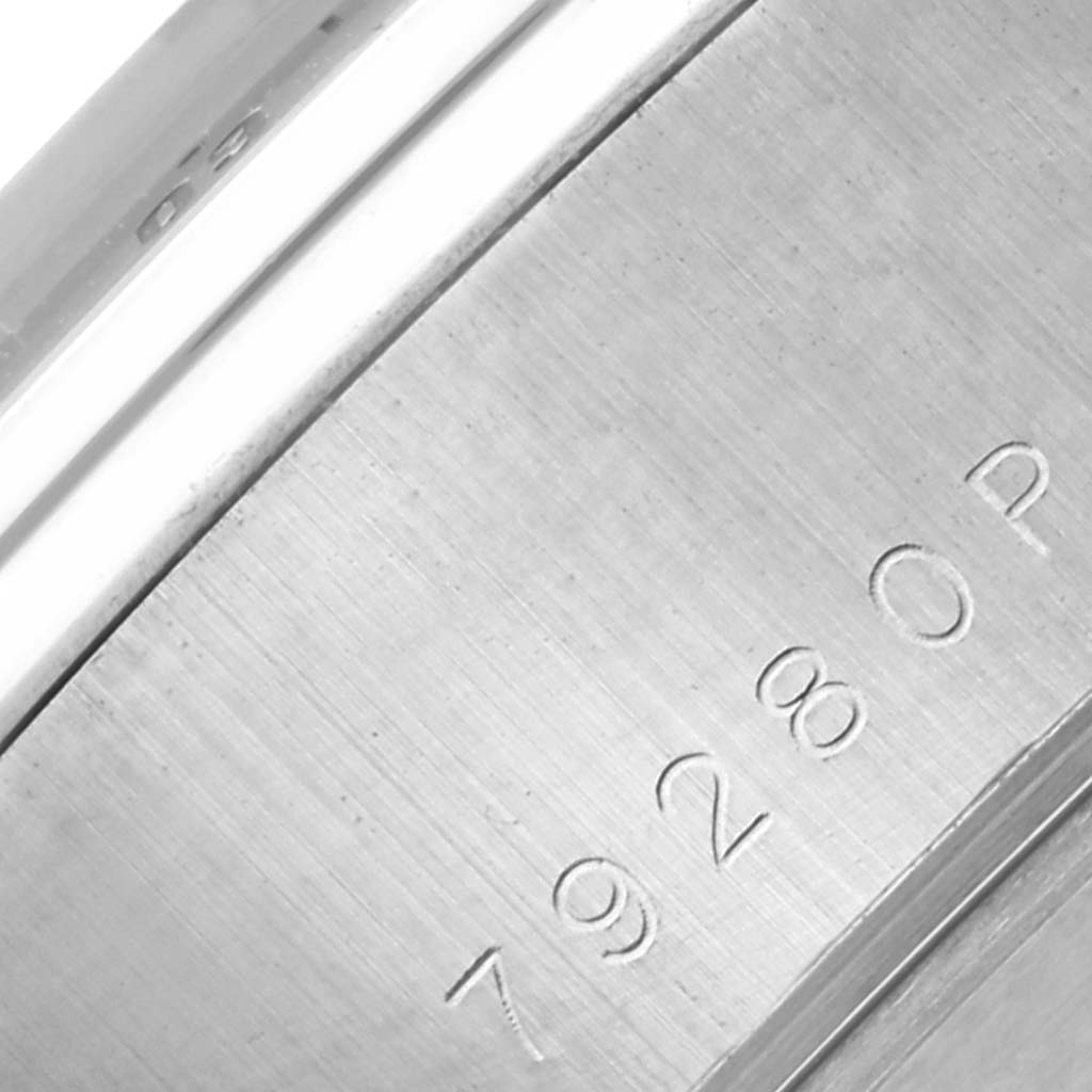 The image shows a close-up of the case back of a Tudor Tiger 79280P Men's Stainless Steel Red Dial 79280P Men's Stainless Steel Red Dial watch, focusing on engraved details and brushed metal texture.