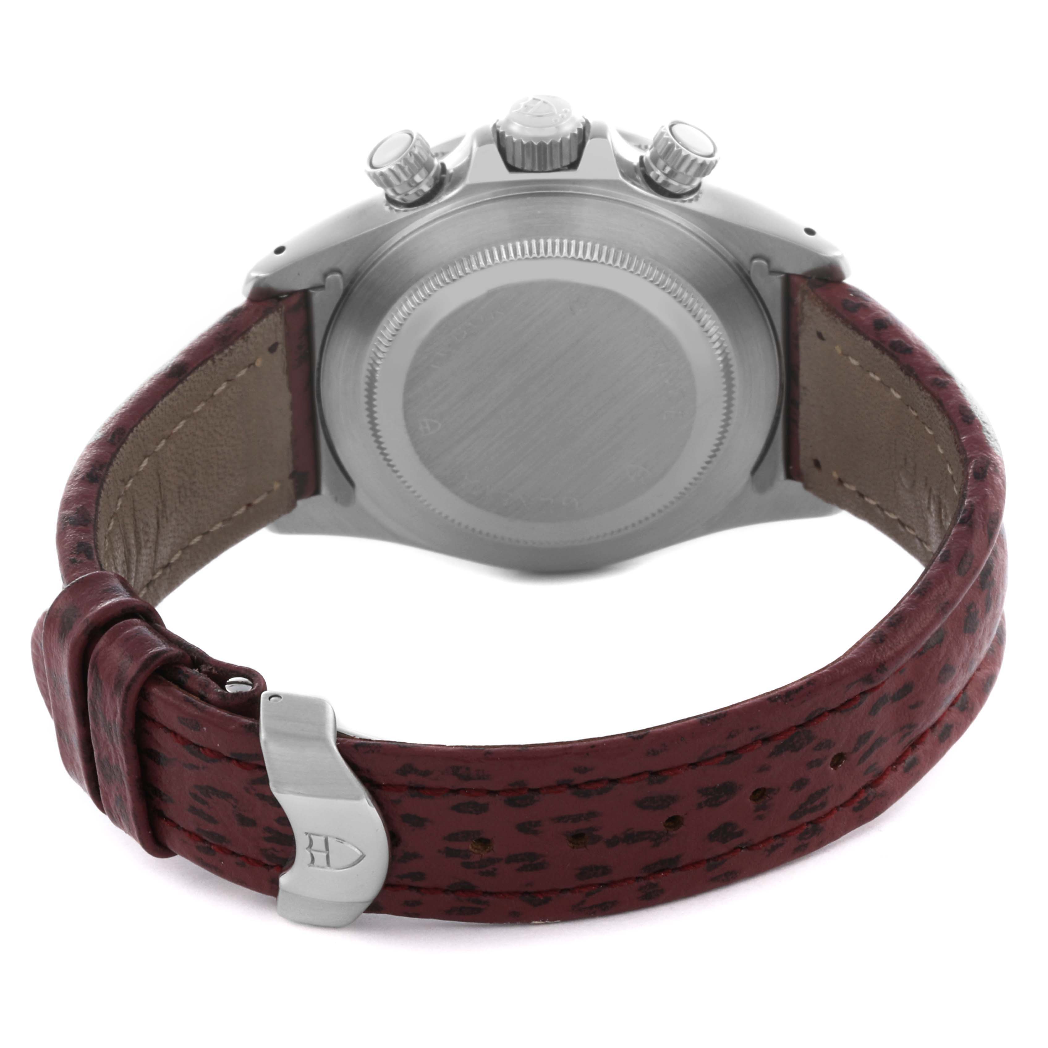 The image shows the Tudor Tiger 79280P Men's Stainless Steel Red Dial 79280P Men's Stainless Steel Red Dial model from the back, featuring the case back, crown, pushers, and leather strap with a clasp.