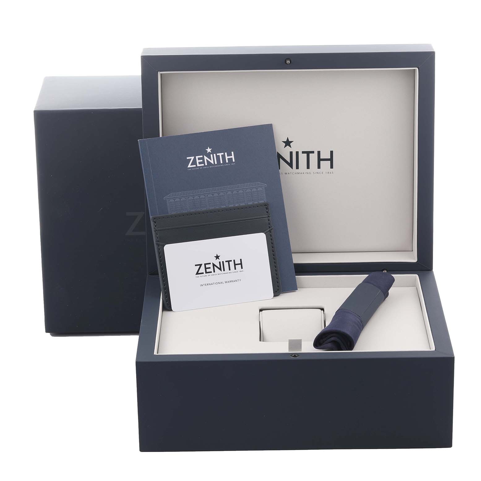 The image shows the Zenith Chronomaster 03.3107.3600/56.M3100 Men
s Stainless Steel Green Dial 03.3107.3600/56.M3100 Men
s Stainless Steel Green Dial watch packaging, including a box, booklet, card, and strap, viewed from the front.