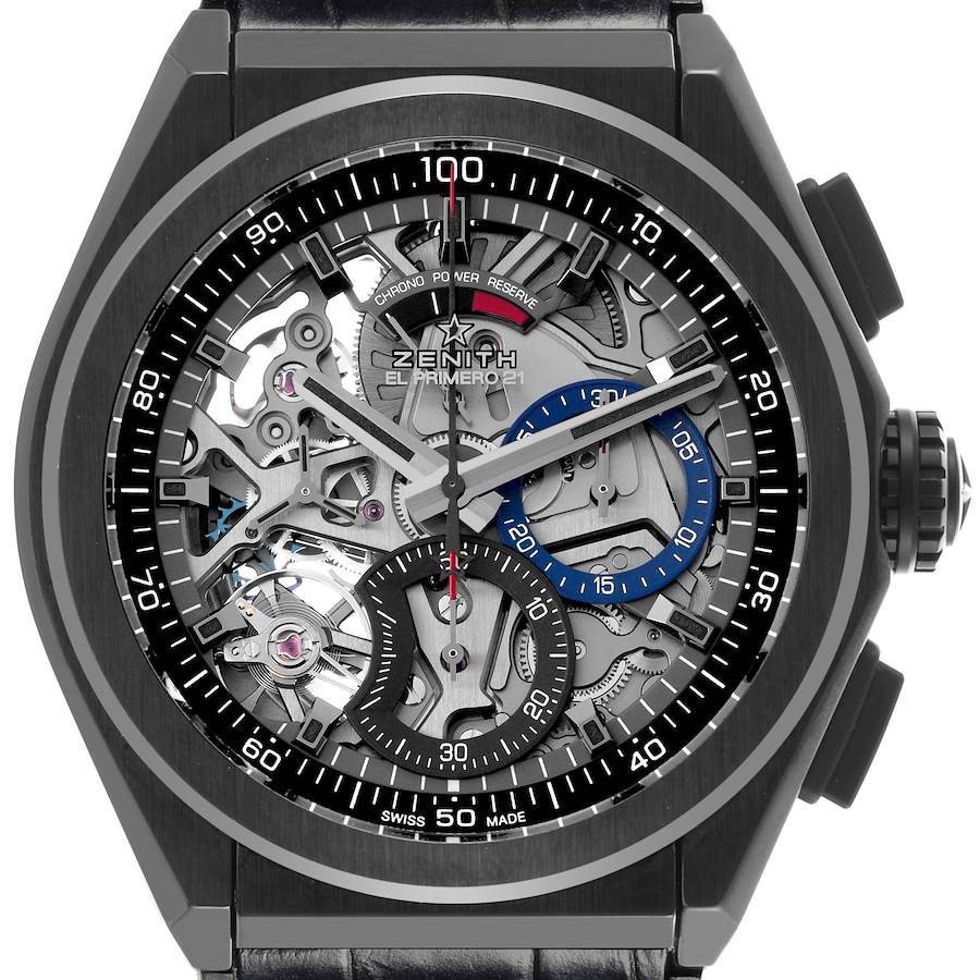 The image shows a Zenith Defy watch from a front angle, highlighting its skeleton dial and chronograph features.