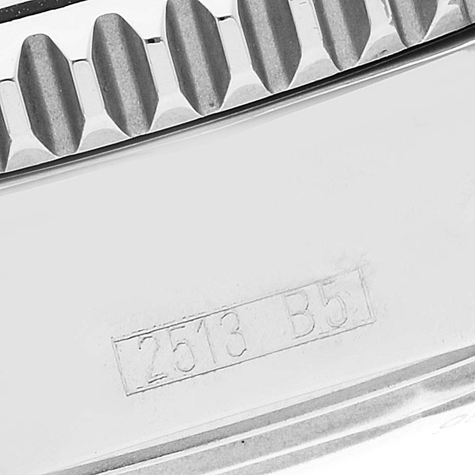 This image shows a close-up of the bezel and engraved serial number on the case of a Breitling Superocean A17364 Men's Stainless Steel Black Dial A17364 Men's Stainless Steel Black Dial watch.