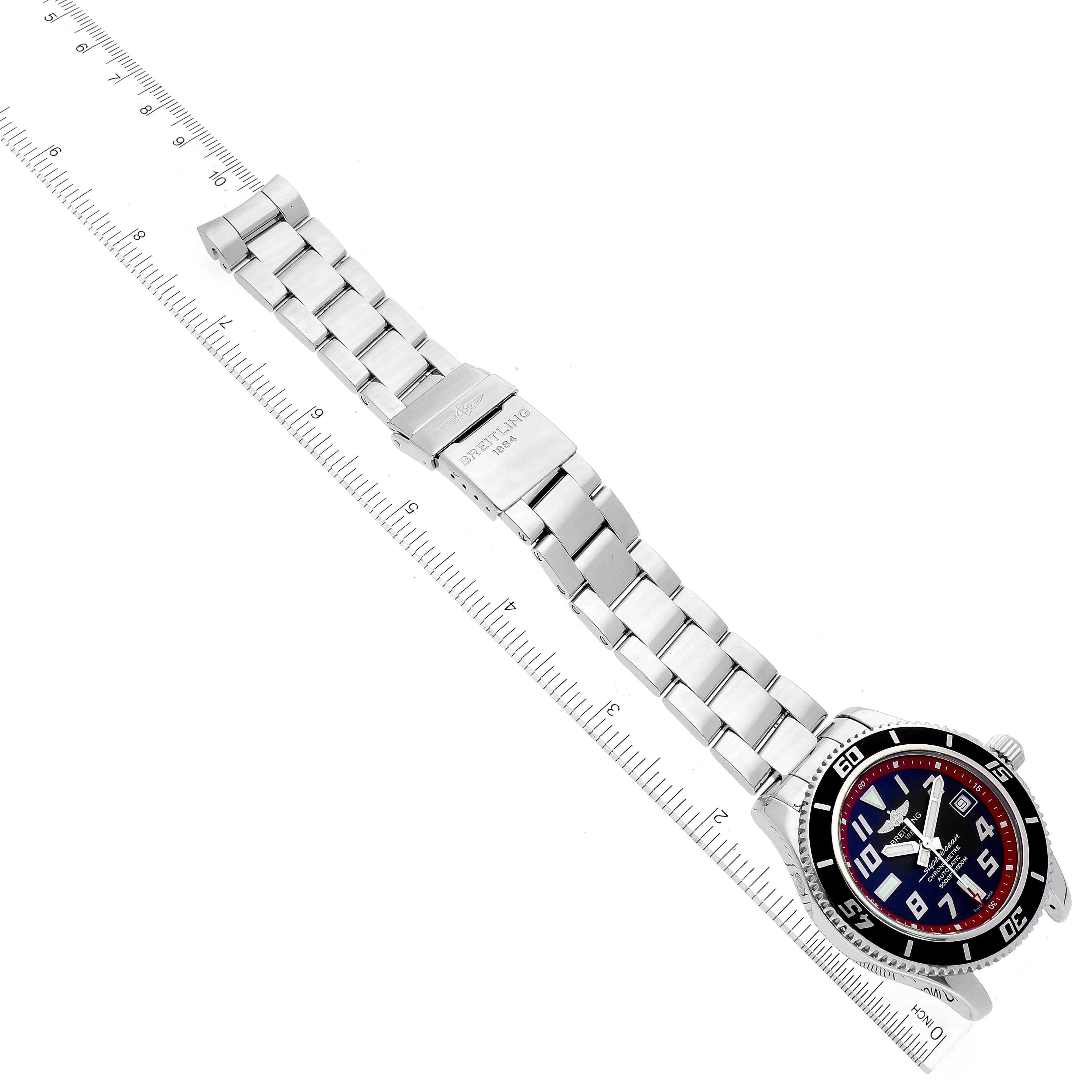 The image shows a Breitling Superocean A17364 Men's Stainless Steel Black Dial A17364 Men's Stainless Steel Black Dial watch placed diagonally, displaying the watch face and metal bracelet alongside a ruler.