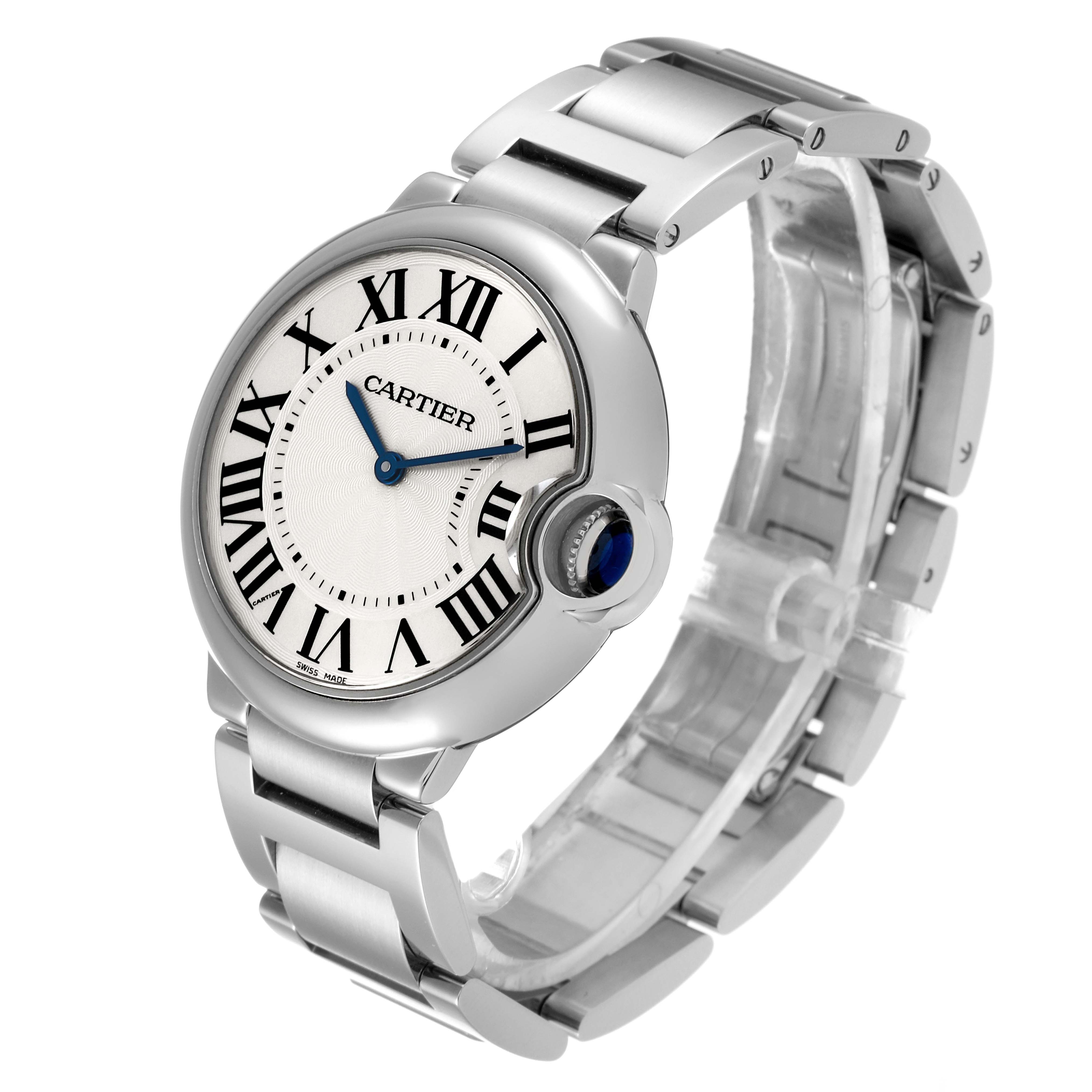 The Ballon Bleu by Cartier is shown at an angled side view, highlighting the round face, Roman numerals, and metal bracelet.