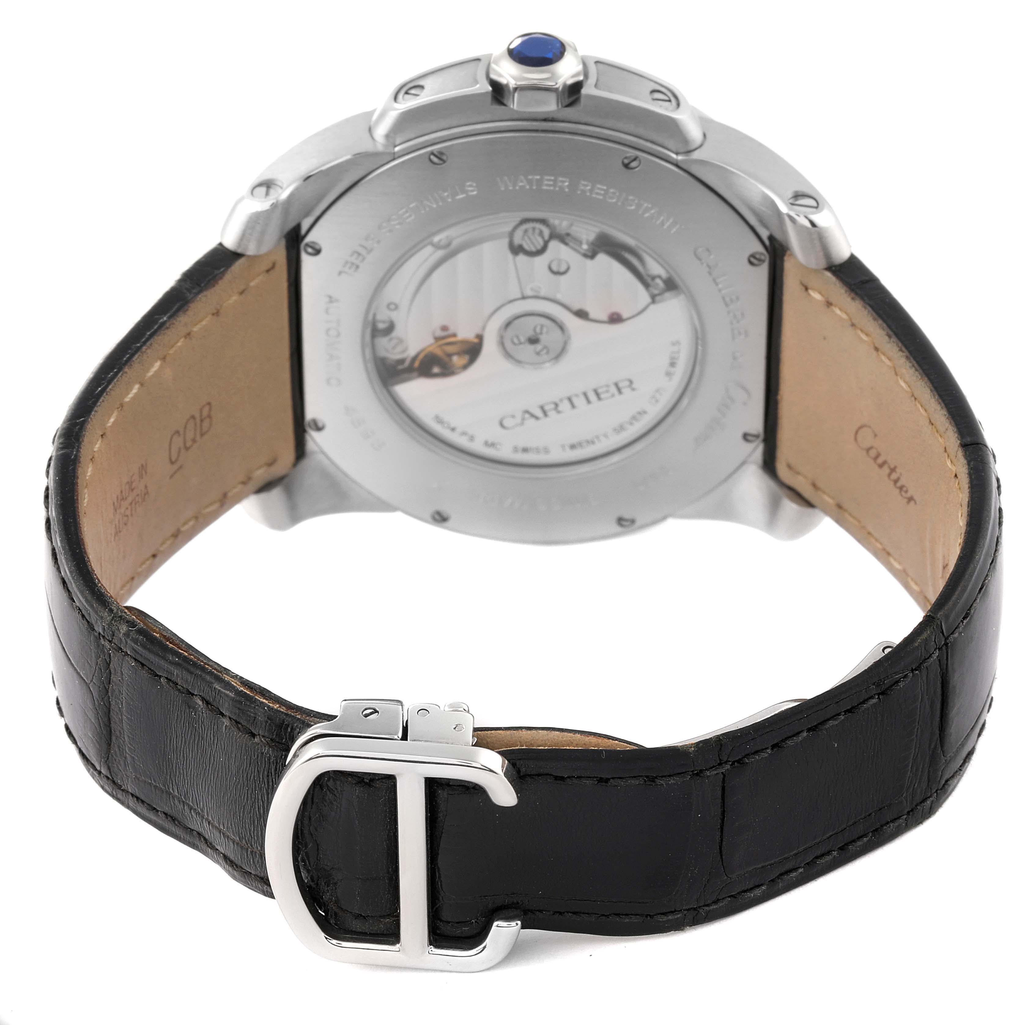 The image shows the back view of a Calibre de Cartier model by Cartier, highlighting the case back and leather strap with a "C" buckle.
