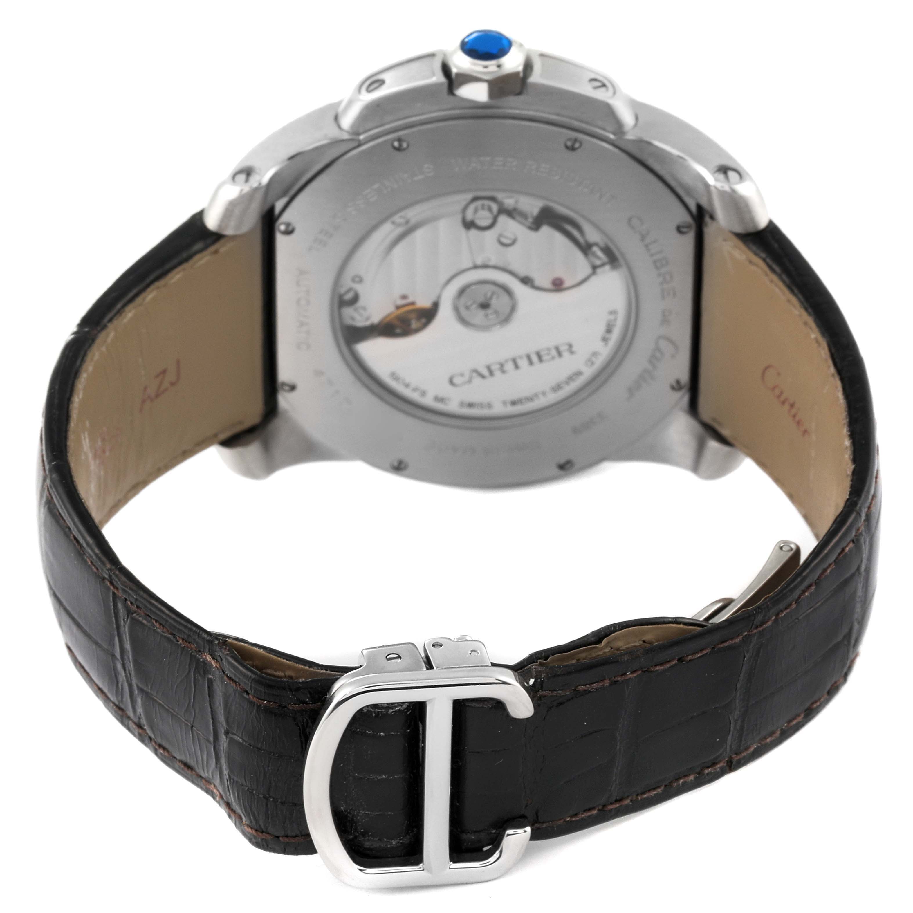 The image shows the rear view of a Calibre de Cartier watch by Cartier, displaying the leather strap and the back of the case.
