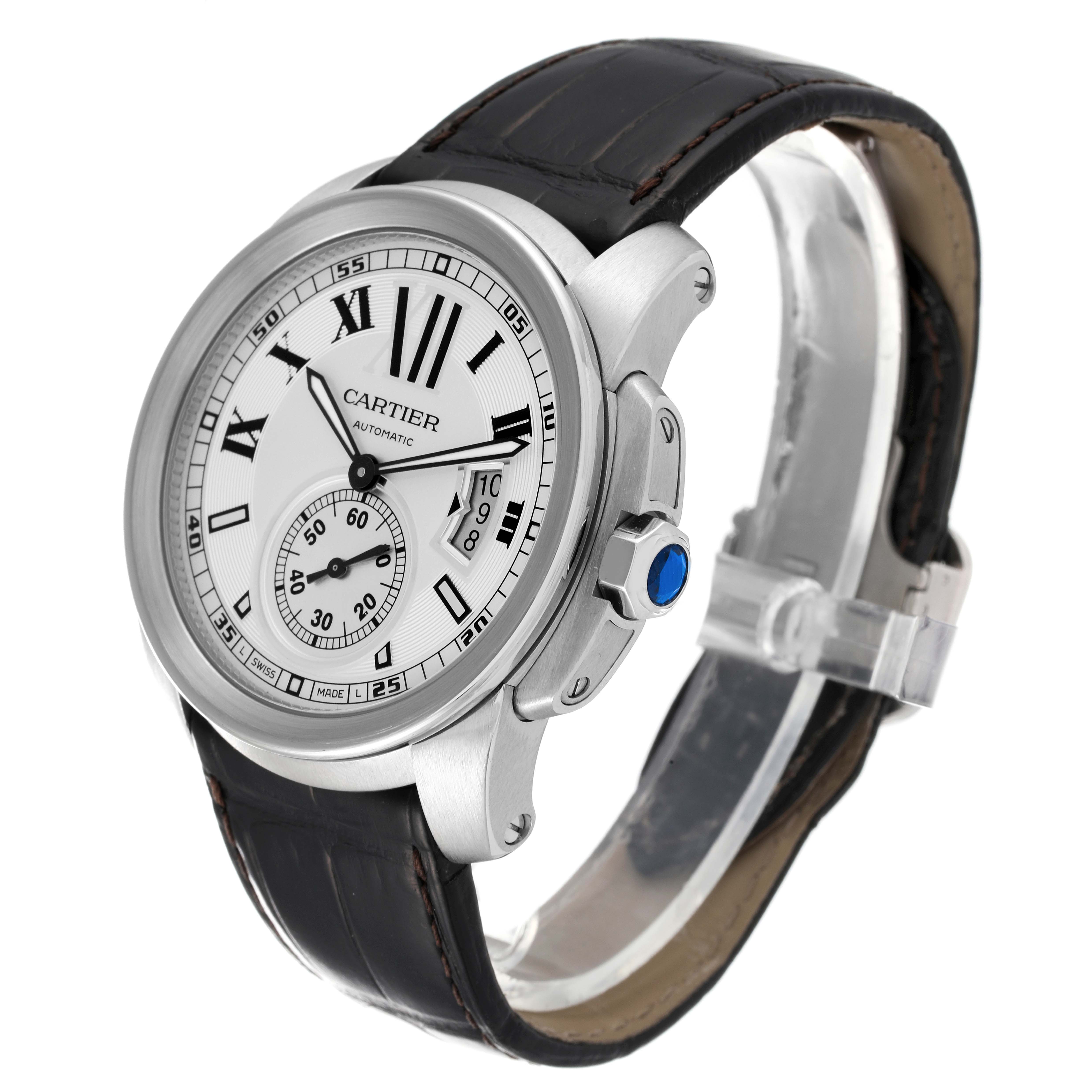 The Calibre de Cartier watch by Cartier is shown at a three-quarter angle, highlighting the face, crown, and leather strap.