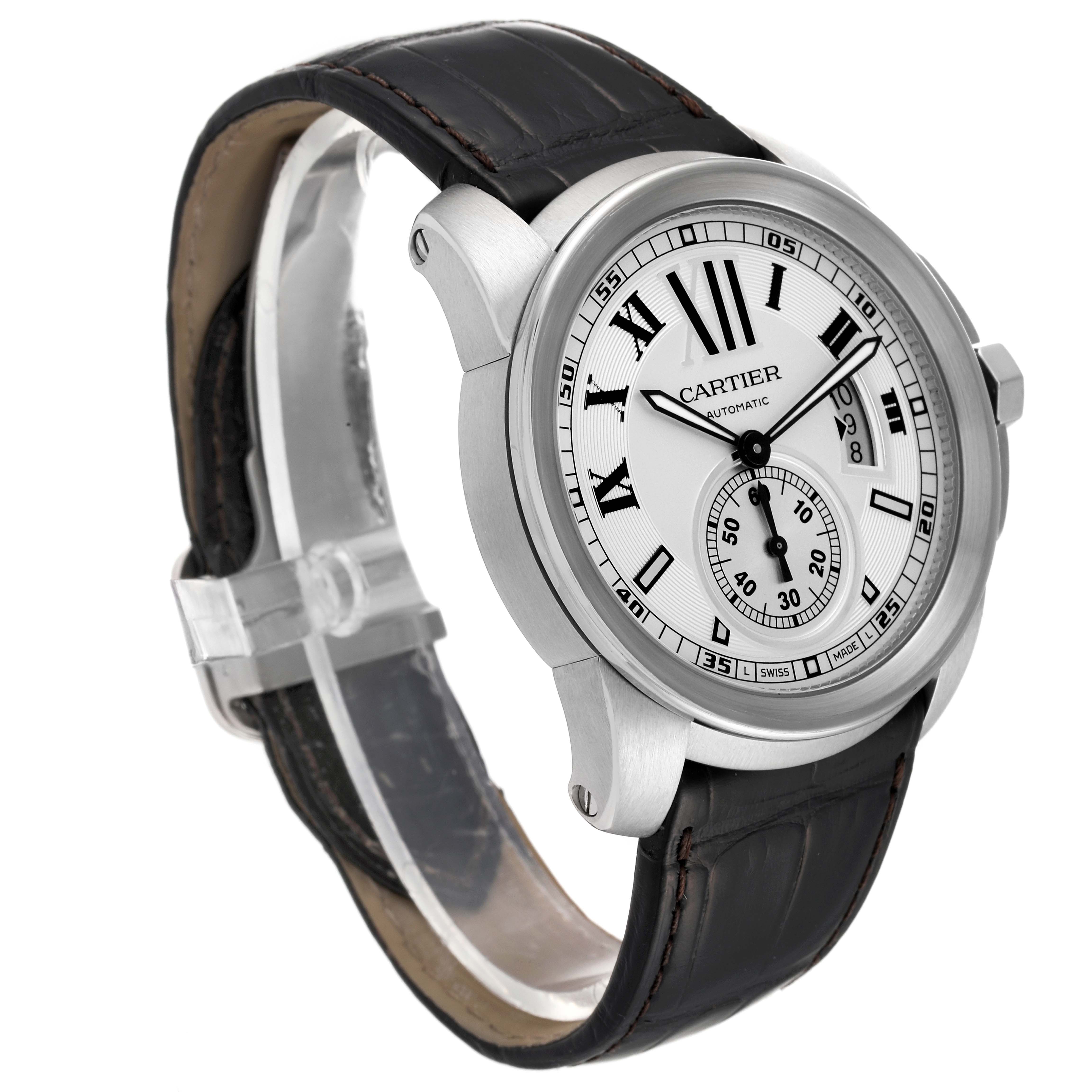 The image shows a Calibre de Cartier watch by Cartier at a three-quarter angle, highlighting its dial, case, and leather strap.