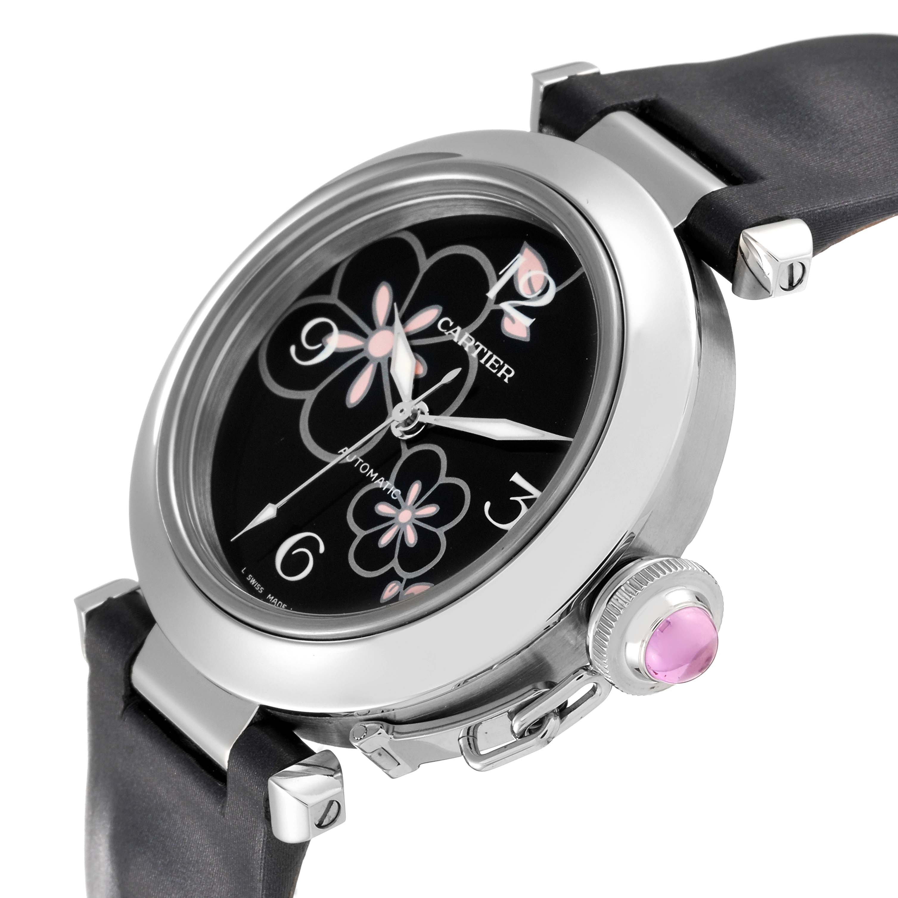 This image shows a Cartier Pasha W3109699 Women's Stainless Steel Black Dial W3109699 Women's Stainless Steel Black Dial watch from an angled view highlighting its face, strap, and crown with a pink gem.