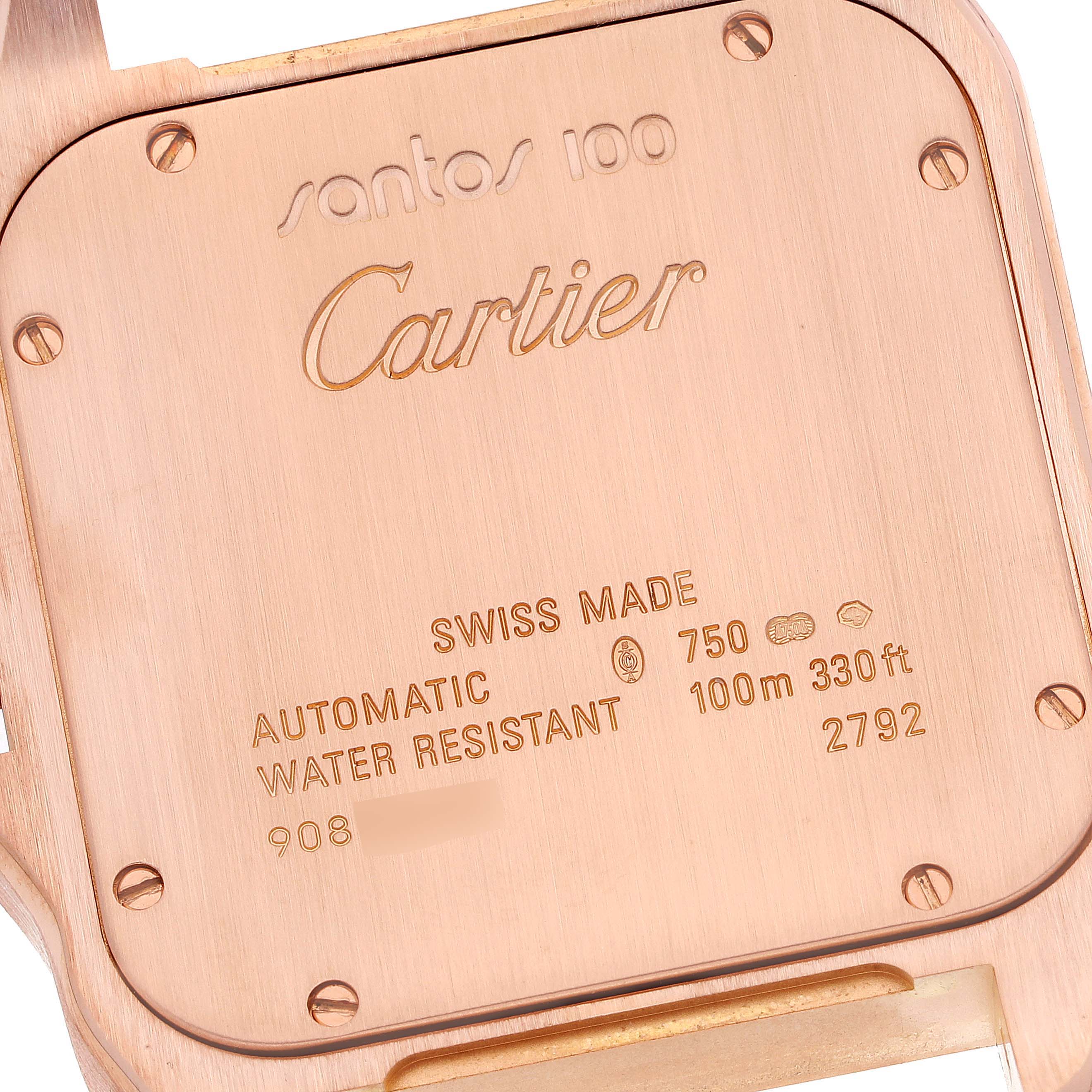 The image shows the back case of a Santos 100 Cartier watch with engraved details.