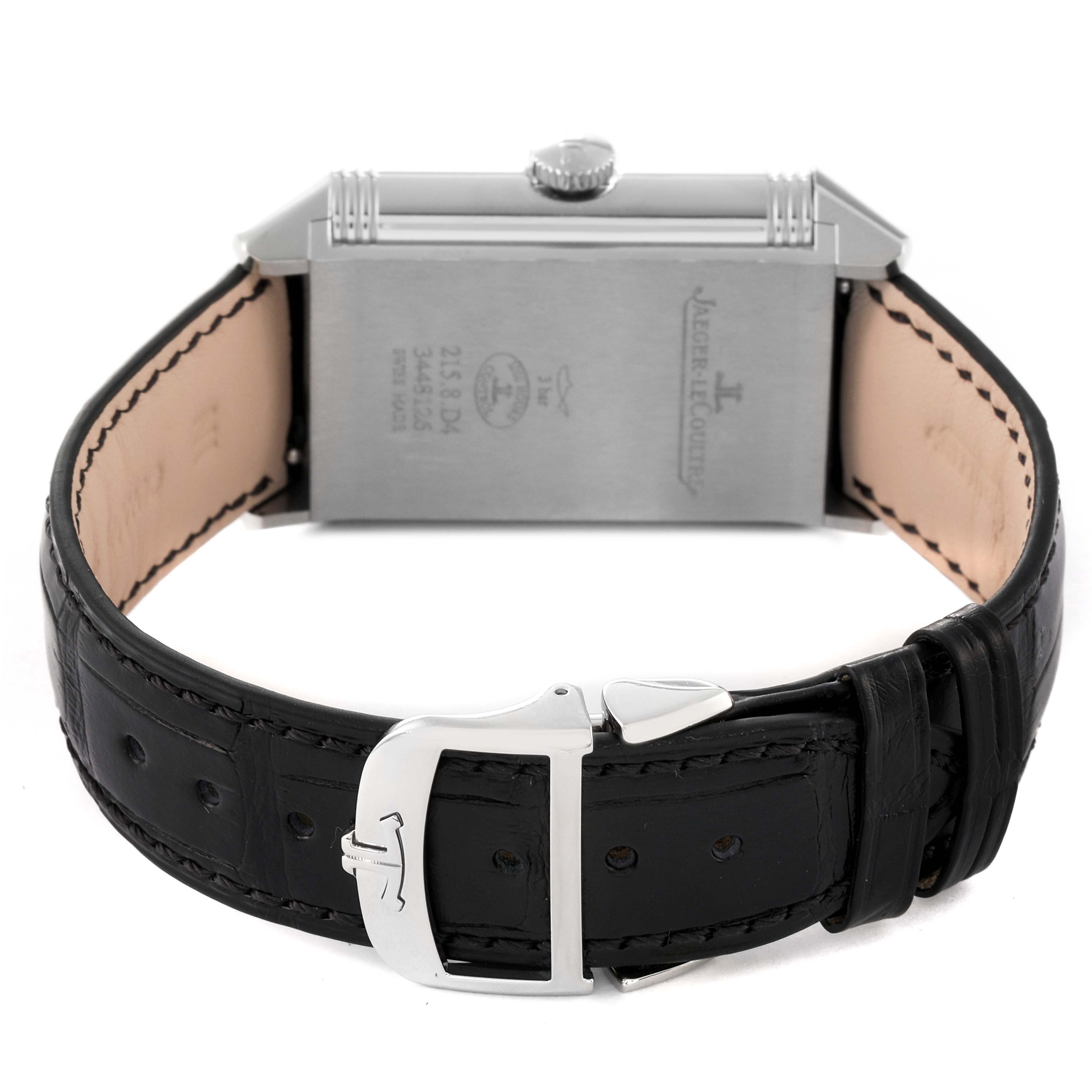 The image shows the back and side of a Jaeger-LeCoultre Reverso watch, including the leather strap and clasp.