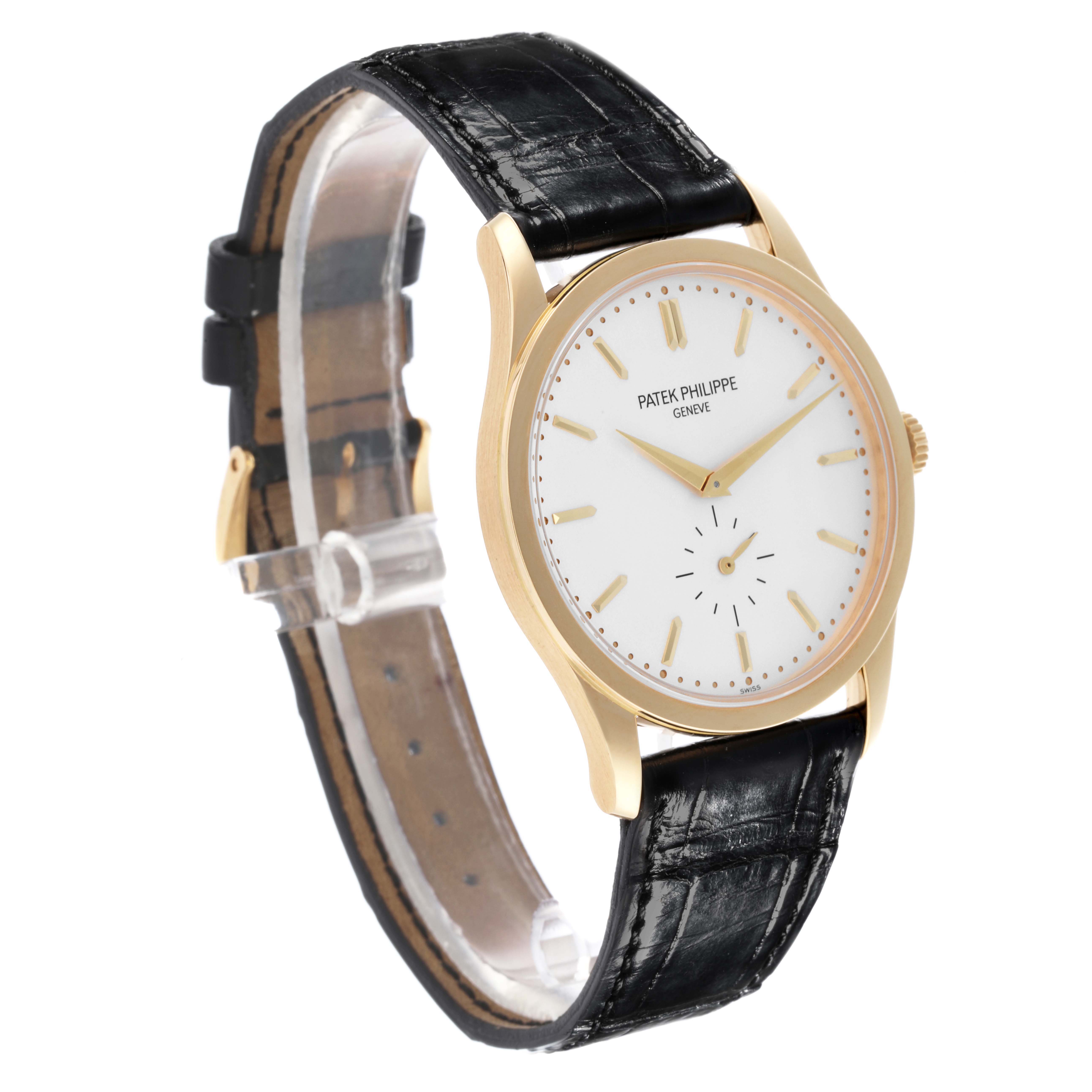 The Patek Philippe Calatrava 5196J Men's Yellow Gold Silver Dial 5196J Men's Yellow Gold Silver Dial watch is shown at a side angle, highlighting the dial, case, and black leather strap.