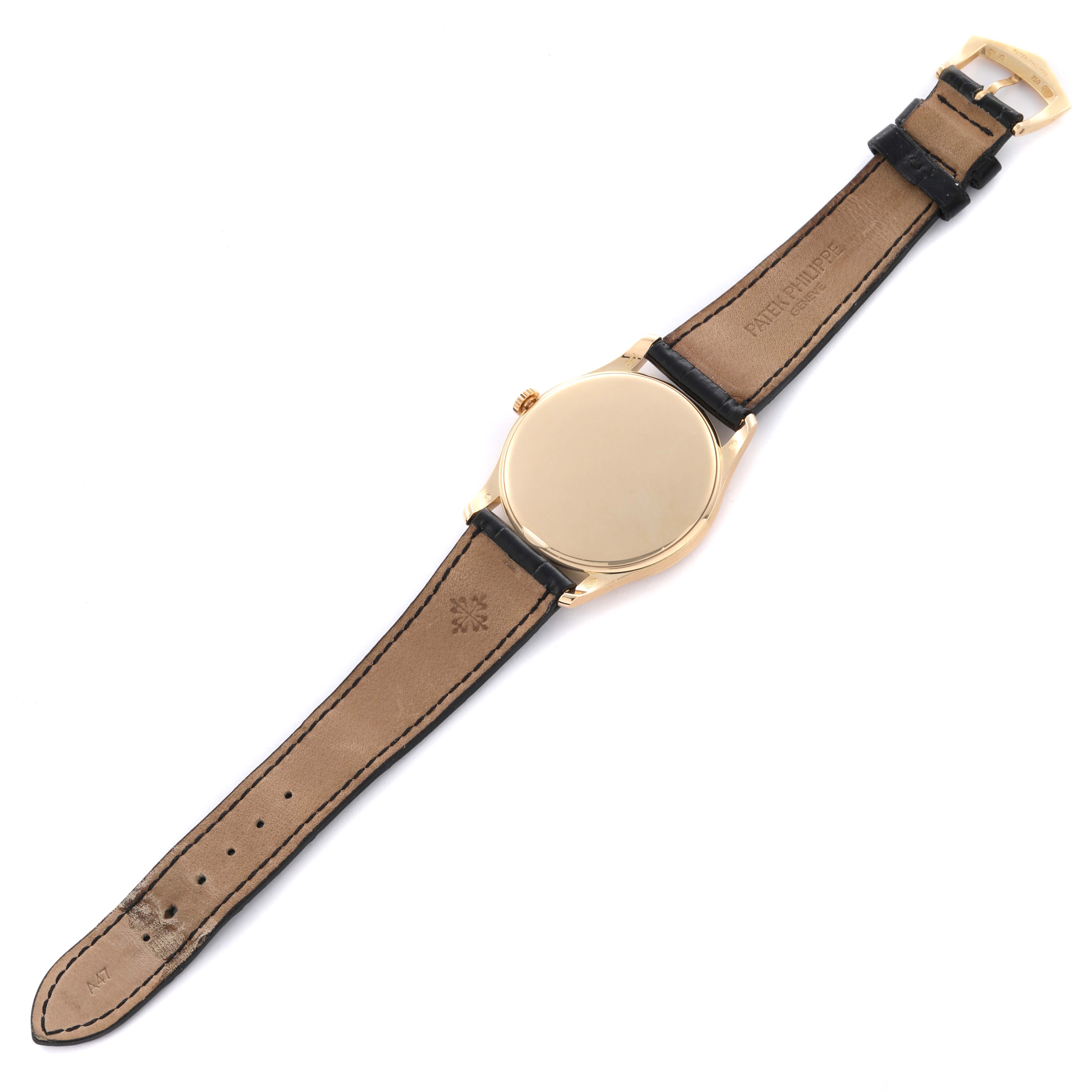 The image shows the back of a Patek Philippe Calatrava 5196J Men's Yellow Gold Silver Dial 5196J Men's Yellow Gold Silver Dial watch, displaying the case back and leather strap from a top-down angle.