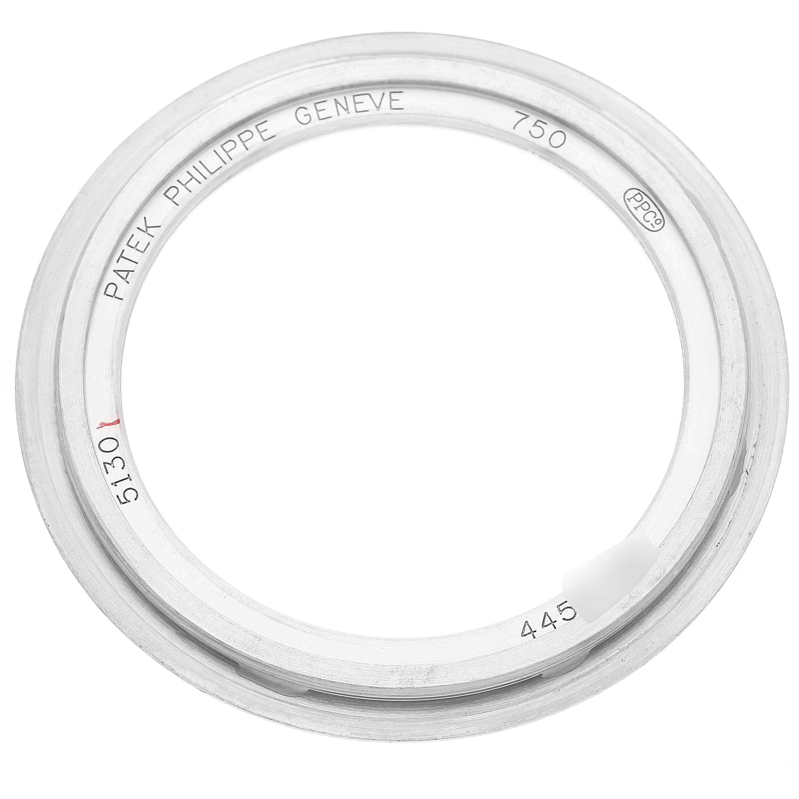 This image shows a bezel for the Patek Philippe Complications 5130G Men's White Gold Silver Dial 5130G Men's White Gold Silver Dial model, viewed from a top-down angle.