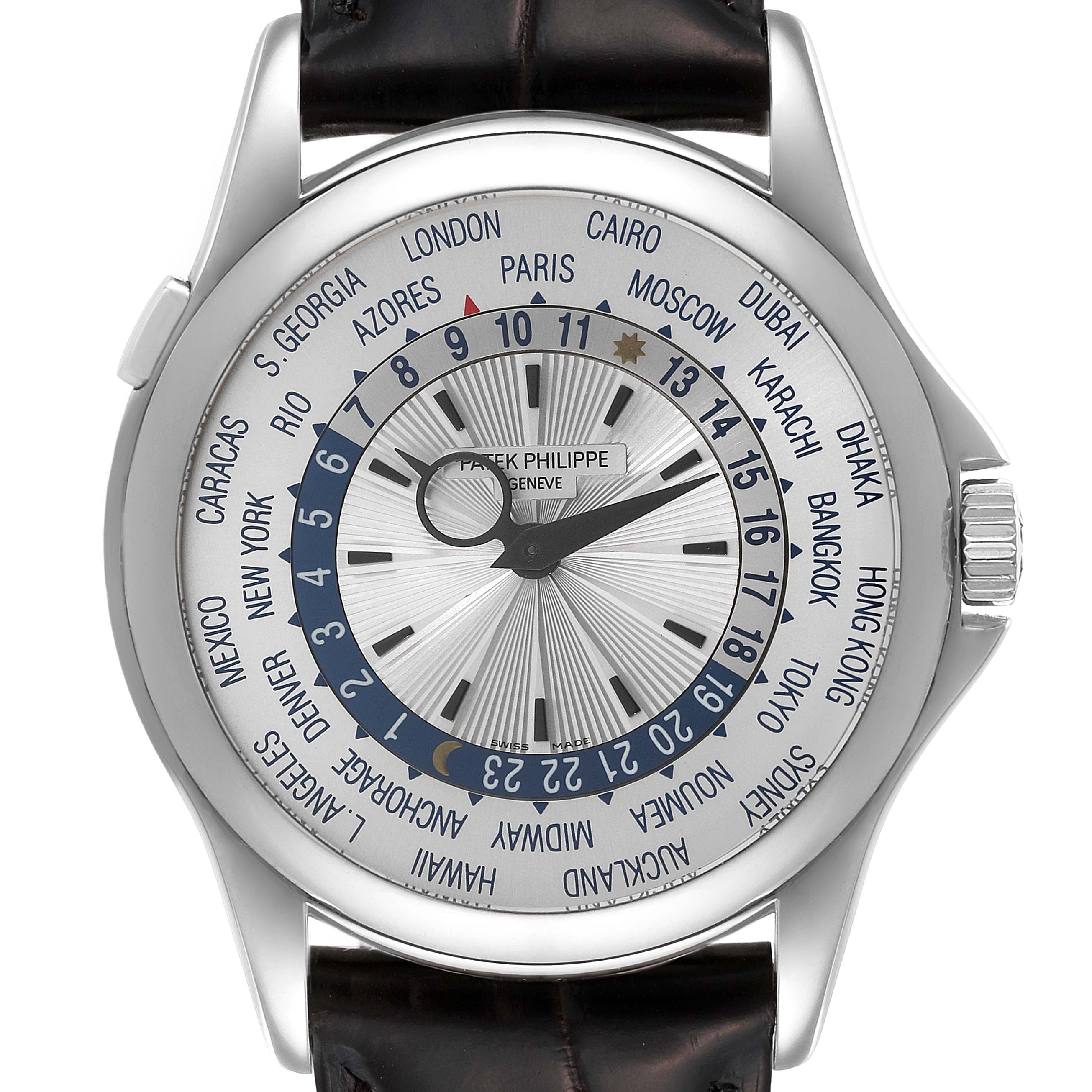 The image shows a front view of the Patek Philippe Complications 5130G Men's White Gold Silver Dial 5130G Men's White Gold Silver Dial watch, highlighting its world time function and leather strap.