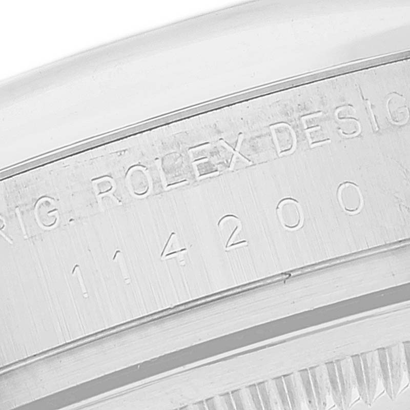 This close-up image shows the engraved details on the case of the Rolex Air-King 114200 Men's Stainless Steel Silver Dial 114200 Men's Stainless Steel Silver Dial watch.