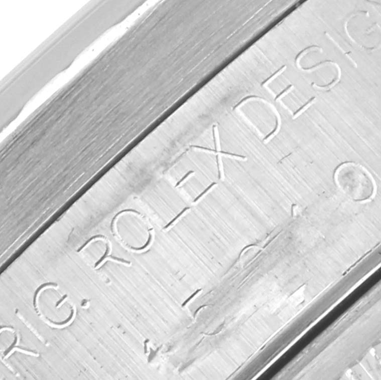 The image shows an engraving on the case side of a Rolex Date 15210 Men
s Stainless Steel Black Dial 15210 Men
s Stainless Steel Black Dial watch at a close angle.