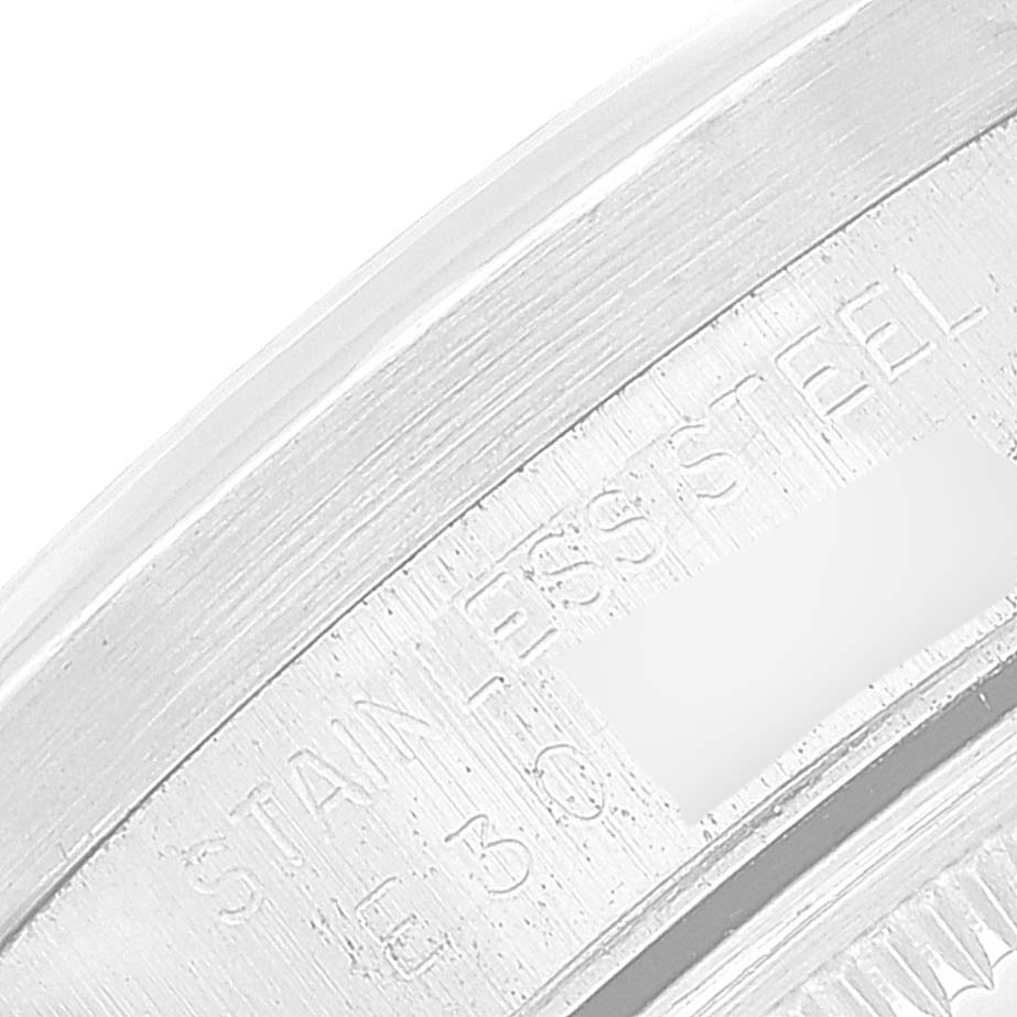 The image shows a close-up view of the engraved edge of a stainless steel Rolex Date 15210 Men
s Stainless Steel Silver Dial 15210 Men
s Stainless Steel Silver Dial model watch.