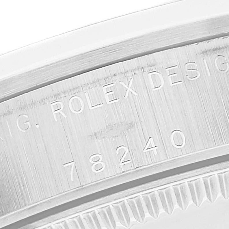 This close-up image of a Mid-Size model Rolex watch shows the engraved serial number and part of the case.