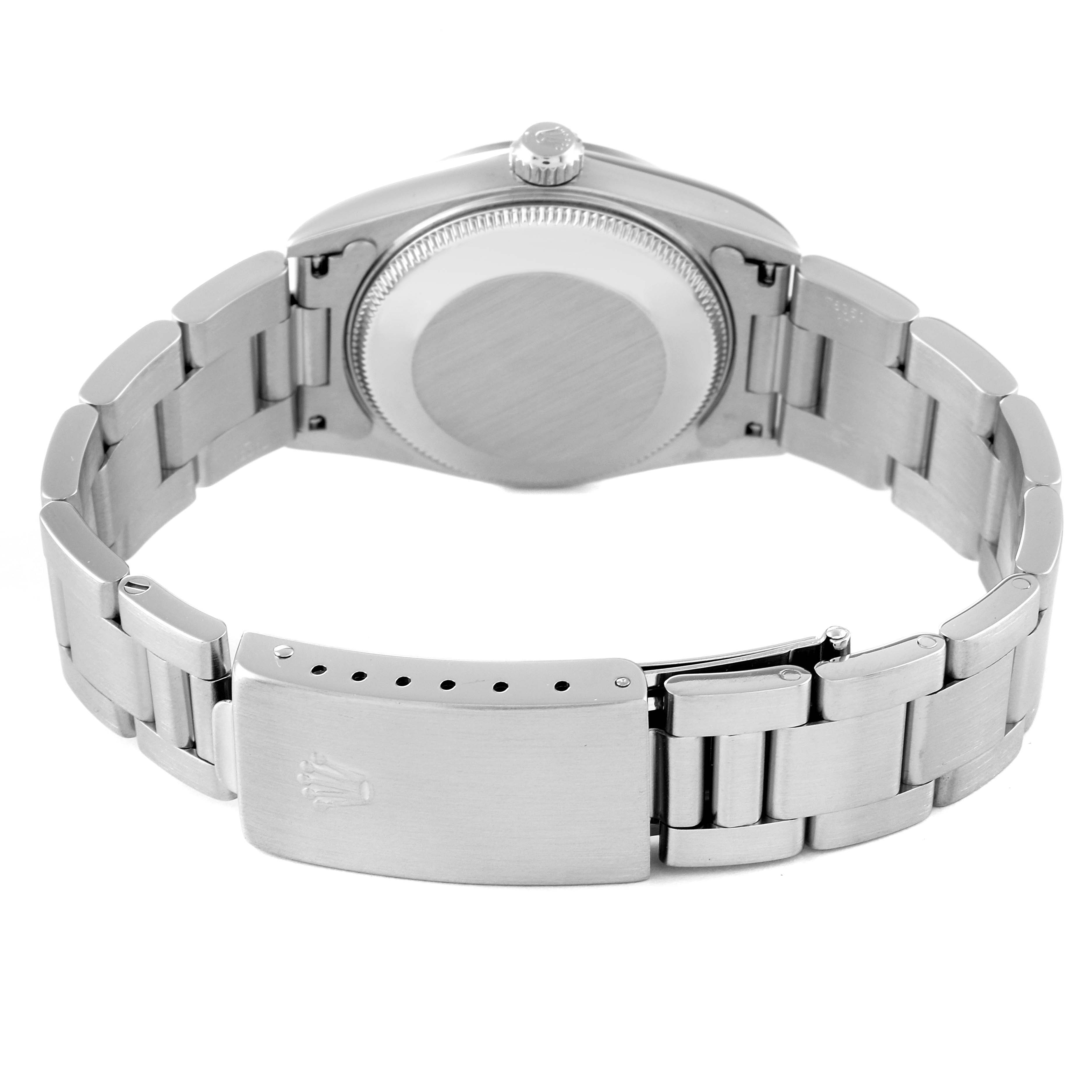 The image shows the back and bracelet of a Mid-Size Rolex watch, revealing the clasp and case back.