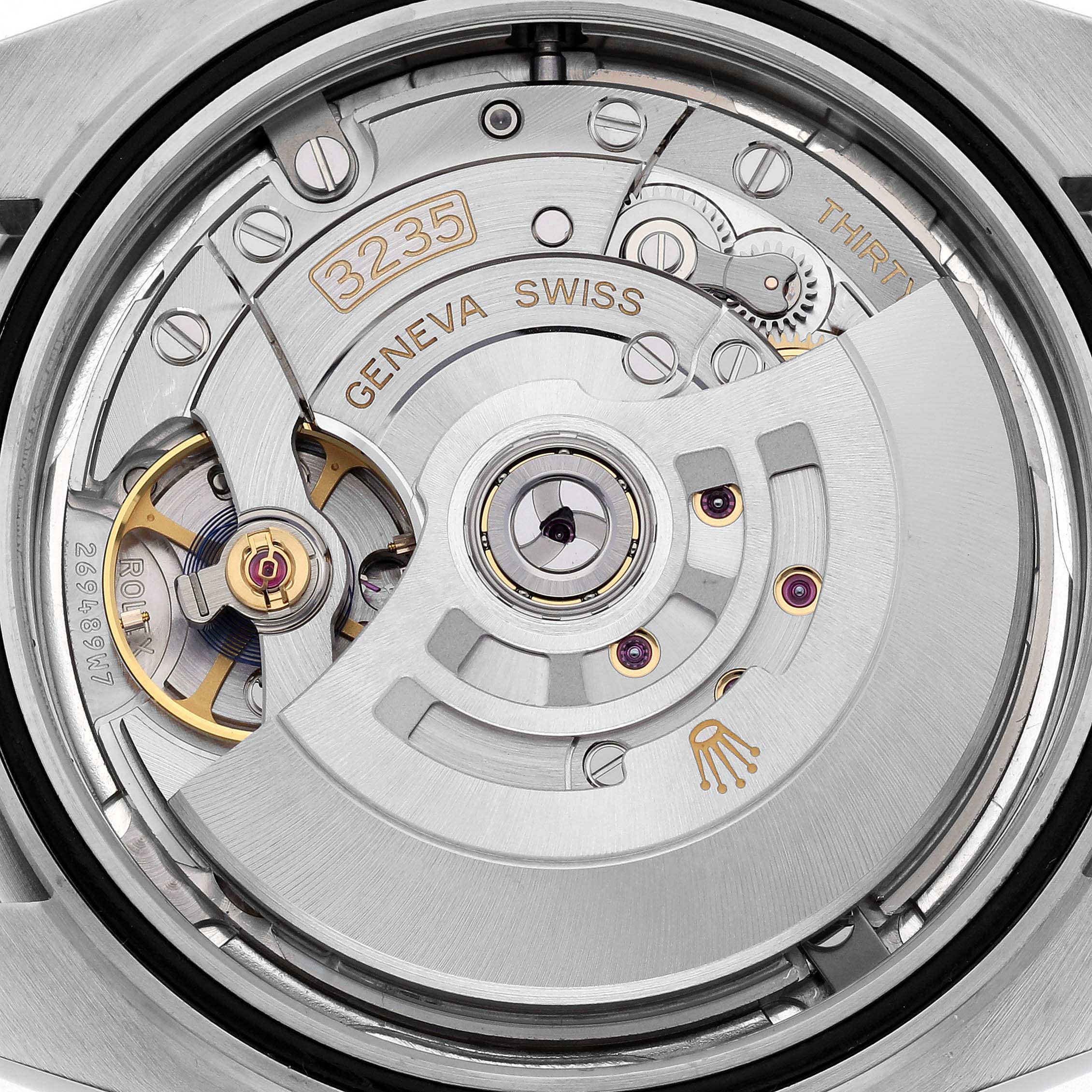 The image shows the movement mechanism of a Rolex Datejust 41 126300 Men's Stainless Steel Silver Dial 126300 Men's Stainless Steel Silver Dial from the back, highlighting intricate parts and engravings.