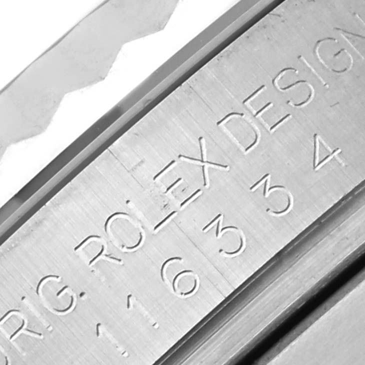 The image shows a close-up of the engraved side of the case of a Rolex Datejust 41 116334 Men
s Stainless Steel Black Dial 116334 Men
s Stainless Steel Black Dial, featuring design details.