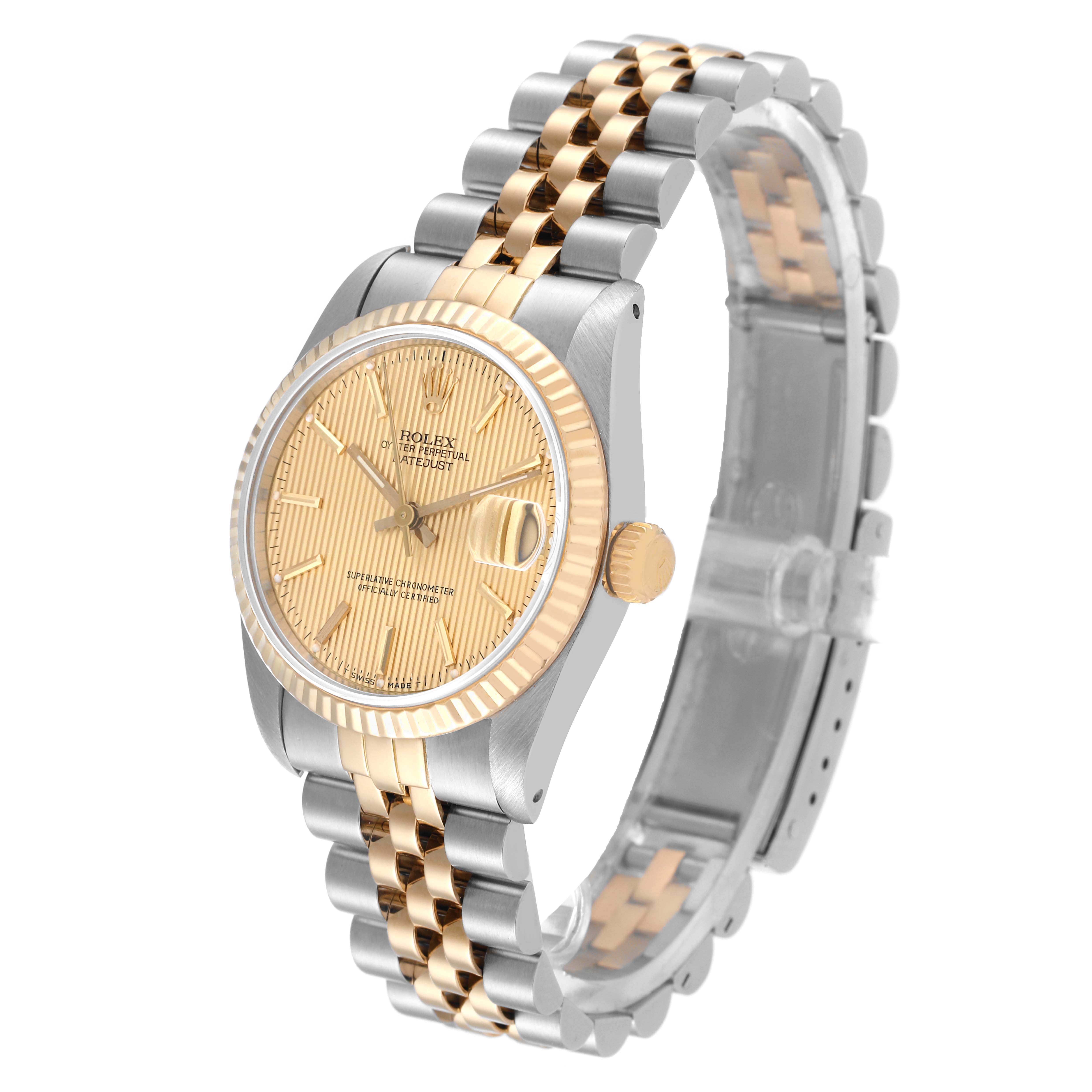 This image shows a Rolex Mid-Size 68273 Women
s Steel and Gold (two tone) Champagne Dial 68273 Women
s Steel and Gold (two tone) Champagne Dial watch at an angled side view, highlighting the face, bezel, and Jubilee bracelet.