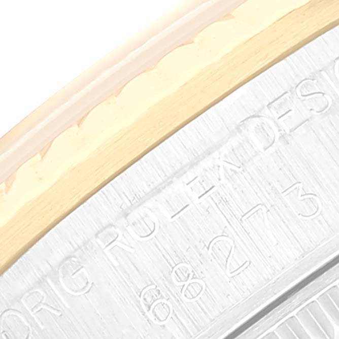 This image shows a close-up of the bezel and part of the case back of a Rolex Mid-Size 68273 Women
s Steel and Gold (two tone) Champagne Dial 68273 Women
s Steel and Gold (two tone) Champagne Dial model watch.