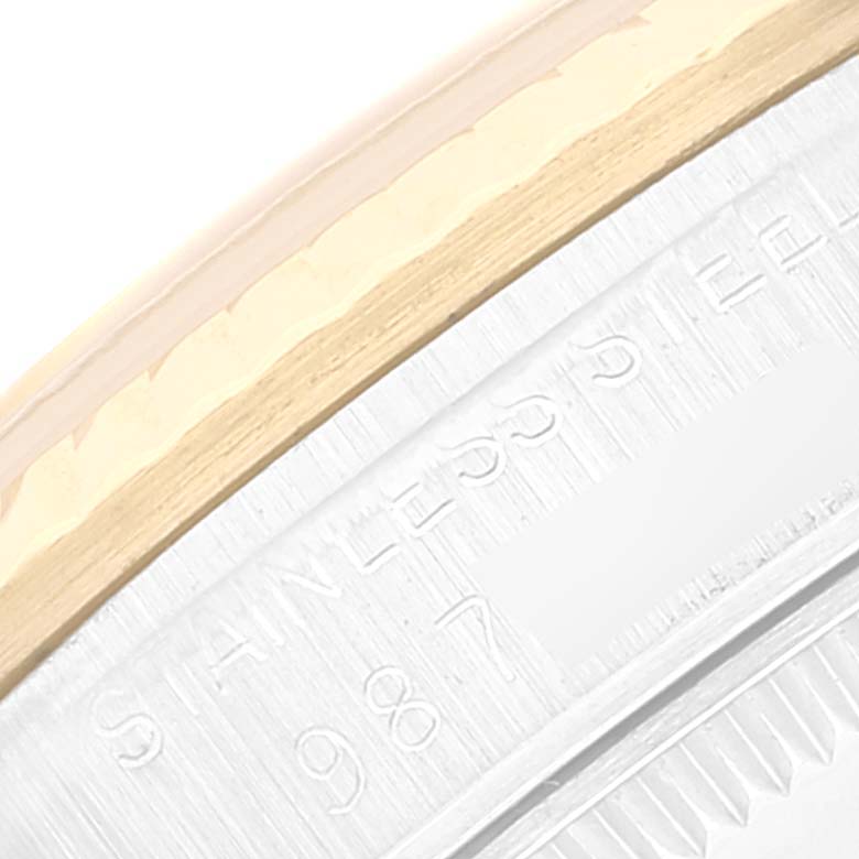 This close-up image of the Rolex Mid-Size 68273 Women
s Steel and Gold (two tone) Champagne Dial 68273 Women
s Steel and Gold (two tone) Champagne Dial model shows part of the caseback edge with stainless steel and gold elements visible.