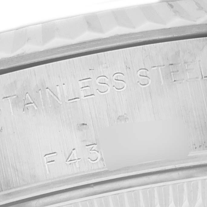 This close-up shows the inner rim of a Rolex Datejust 79174 Women's Stainless Steel Silver Dial 79174 Women's Stainless Steel Silver Dial watch case, highlighting its stainless steel material.