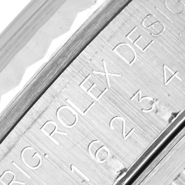 This close-up shows the engraved side detailing of a Rolex Datejust 16234 Men
s Stainless Steel Silver Dial 16234 Men
s Stainless Steel Silver Dial watch case.