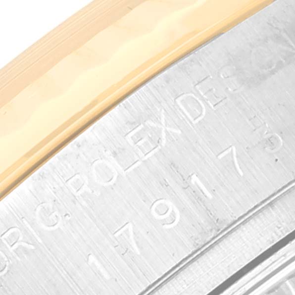 The image shows a close-up of the engraved bezel and edge of the case from a Rolex Datejust 179173 Women's Steel and Gold (two tone) Mother of Pearl Dial 179173 Women's Steel and Gold (two tone) Mother of Pearl Dial watch.