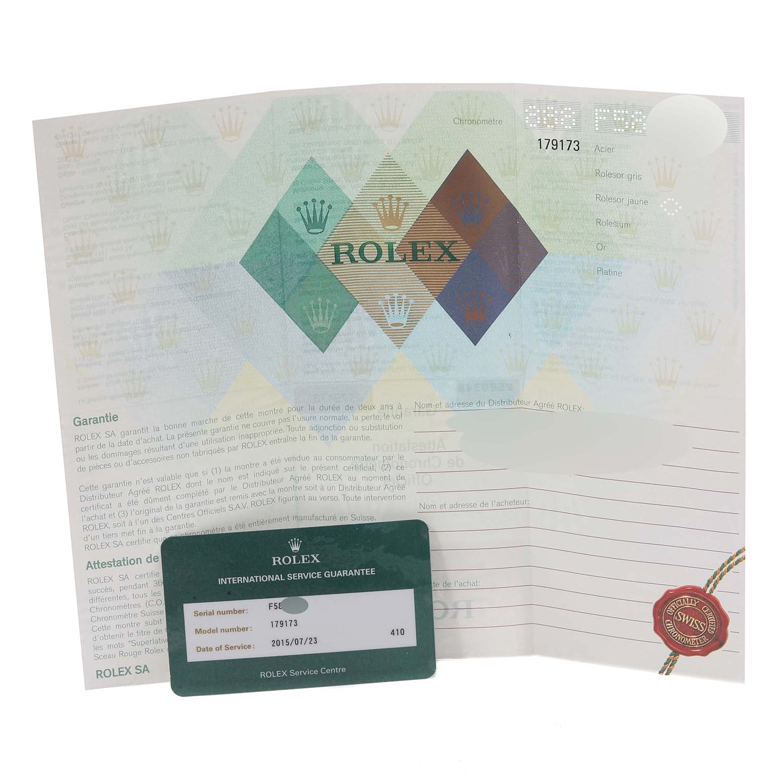 The image shows a Rolex Datejust 179173 Women's Steel and Gold (two tone) Mother of Pearl Dial 179173 Women's Steel and Gold (two tone) Mother of Pearl Dial model's warranty card and documentation from a top view angle.