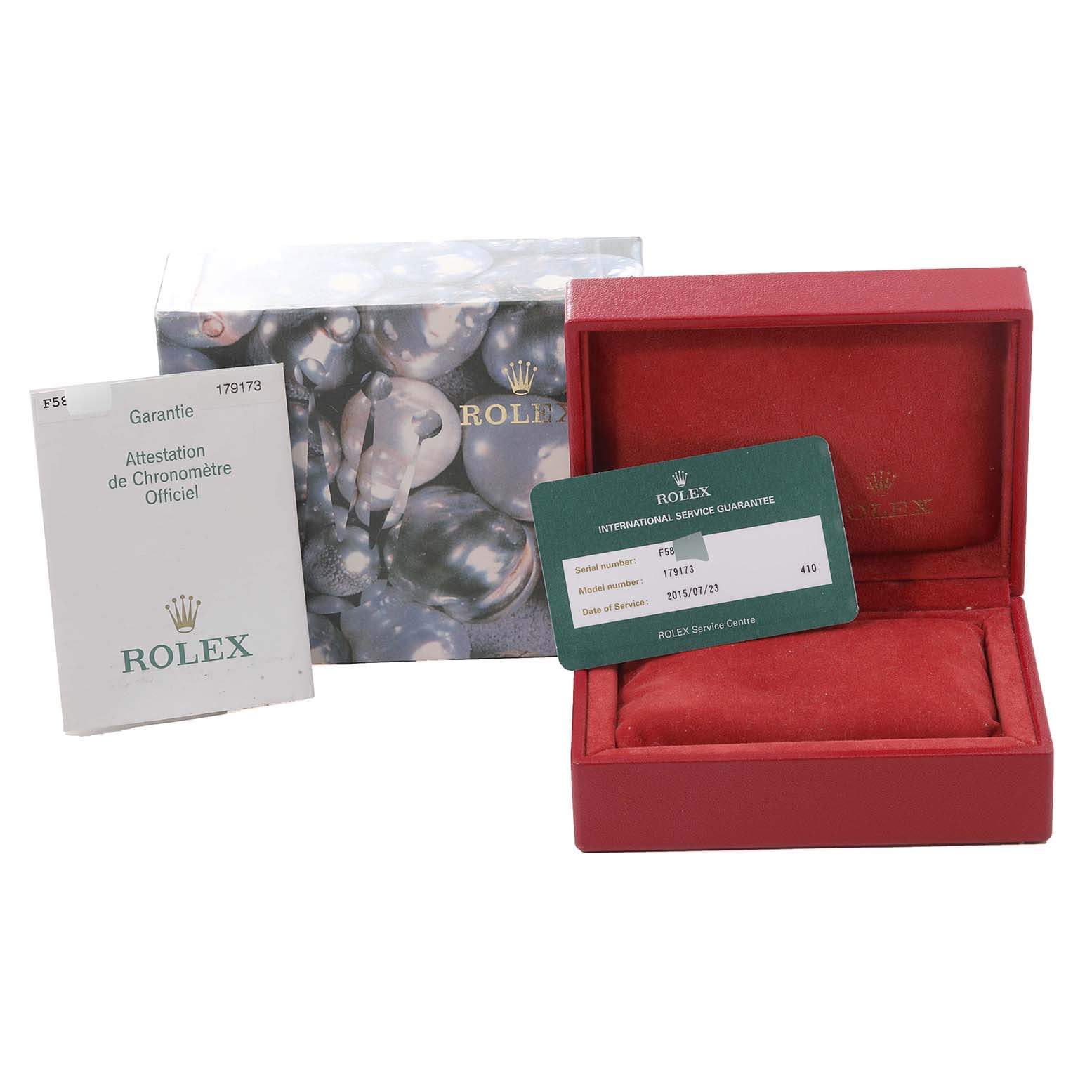 The image shows the accessories of a Rolex Datejust 179173 Women's Steel and Gold (two tone) Mother of Pearl Dial 179173 Women's Steel and Gold (two tone) Mother of Pearl Dial, including a warranty booklet, service guarantee card, and a red watch box.