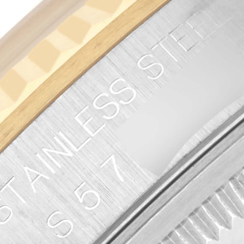 The image shows a close-up of the Rolex Datejust 16233 Men's Steel and Gold (two tone) White Dial 16233 Men's Steel and Gold (two tone) White Dial's stainless steel side and part of the bezel.