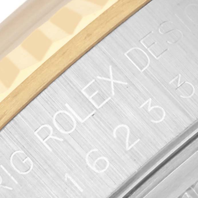 The image shows a close-up of the Rolex Datejust 16233 Men's Steel and Gold (two tone) White Dial 16233 Men's Steel and Gold (two tone) White Dial's bezel edge and engraved side with model details.