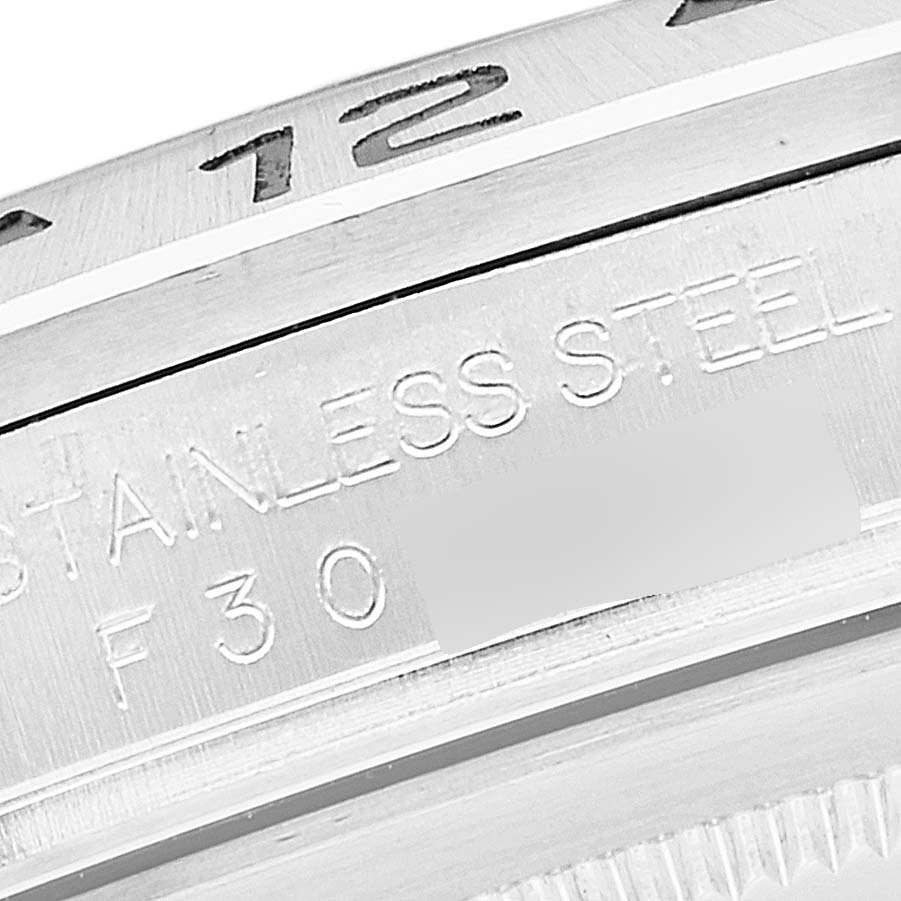 The image shows a close-up of the stainless steel casing and partial bezel of the Rolex Explorer 16570 Men
s Stainless Steel White Dial 16570 Men
s Stainless Steel White Dial watch.