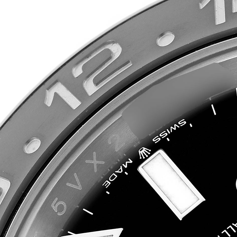 The image shows a close-up of the dial and bezel of a Rolex GMT-Master 126710GRNR Men
s Stainless Steel Black Dial 126710GRNR Men
s Stainless Steel Black Dial, highlighting the 12 numeral and "Swiss Made" text.