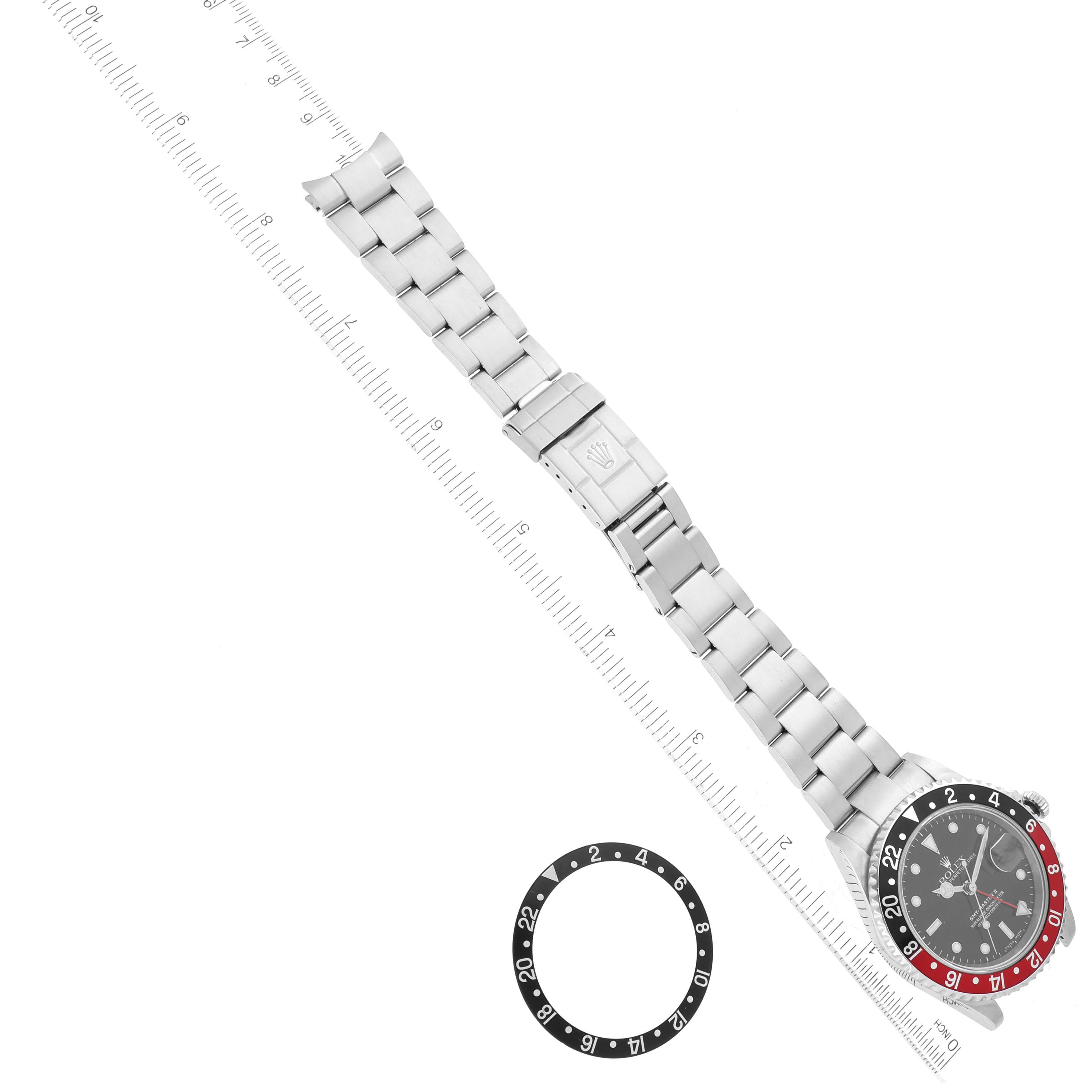 The image shows a Rolex GMT-Master 16710 Men
s Stainless Steel Black Dial 16710 Men
s Stainless Steel Black Dial watch with its bracelet extended and a separate bezel, viewed from above.