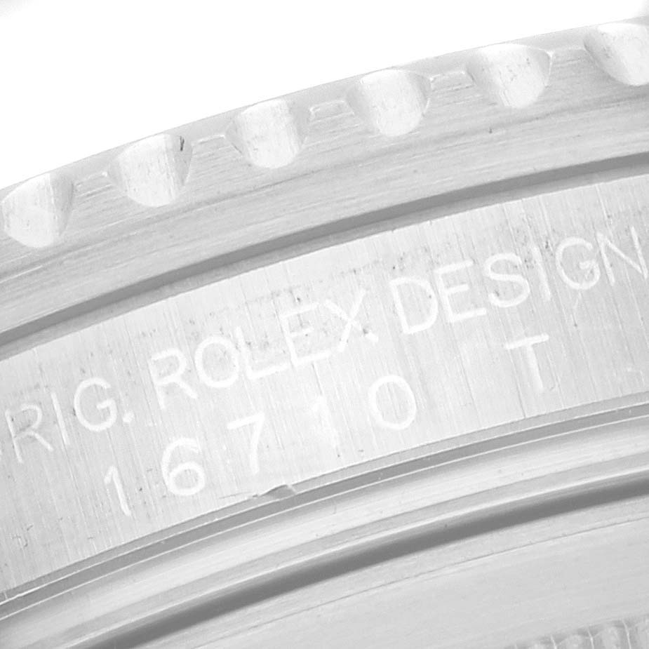 This image shows a close-up of the engraved side case of a Rolex GMT-Master 16710 Men's Stainless Steel Black Dial 16710 Men's Stainless Steel Black Dial watch, displaying the model number 16710 T.